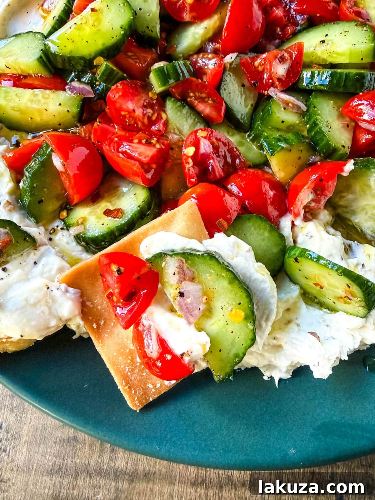 This Greek feta dip is the ultimate party and holiday appetizer that is rich, creamy, and so flavorful! It blends tangy feta, cream cheese, lemon, oregano, and olive oil into a silky whipped dip that feels fancy but takes just minutes to make. Pile it high with tomatoes, cucumbers, and a drizzle of olive oil, then serve with pita chips or veggies.