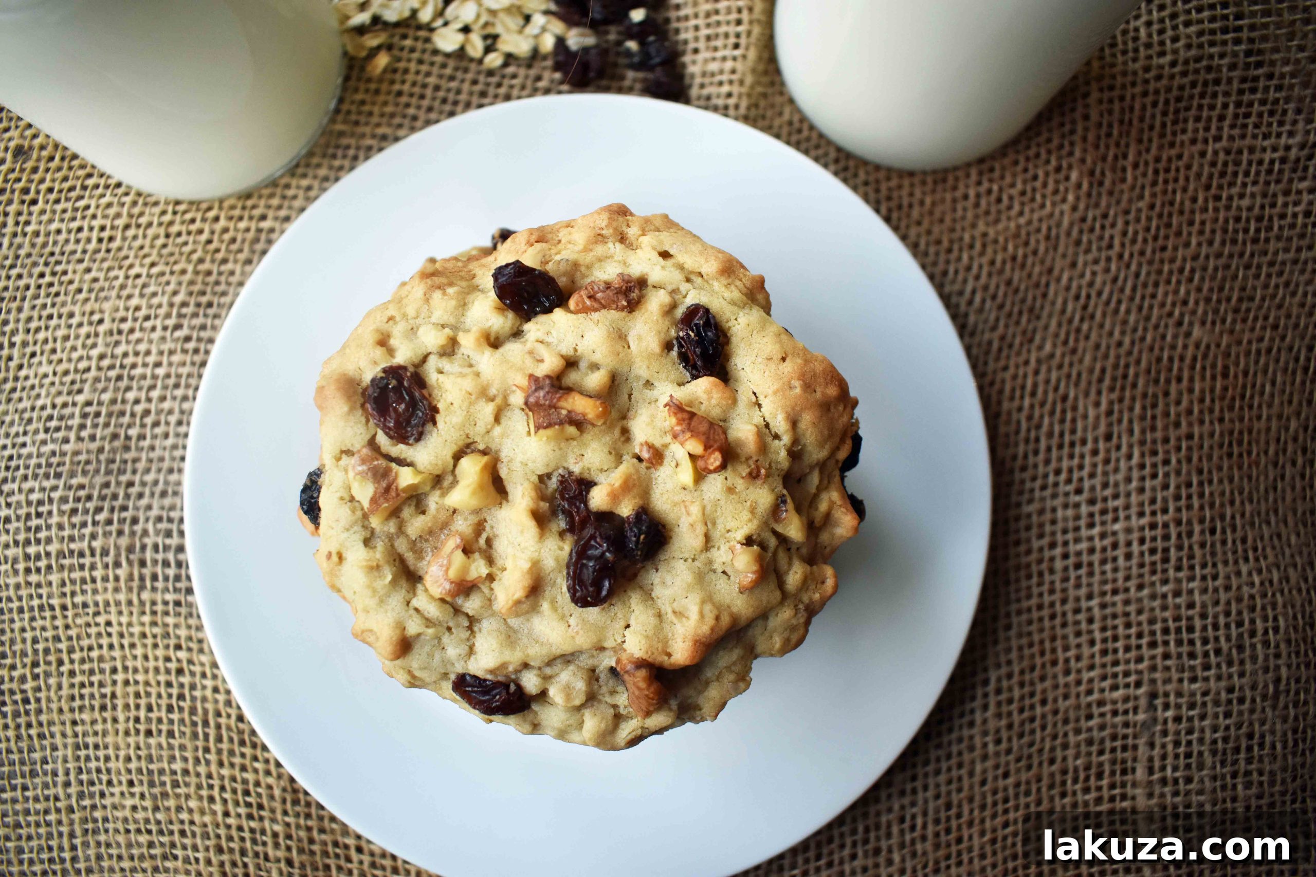 Another view of a large, soft Levain Bakery oatmeal raisin cookie, emphasizing its homemade appeal and inviting texture.