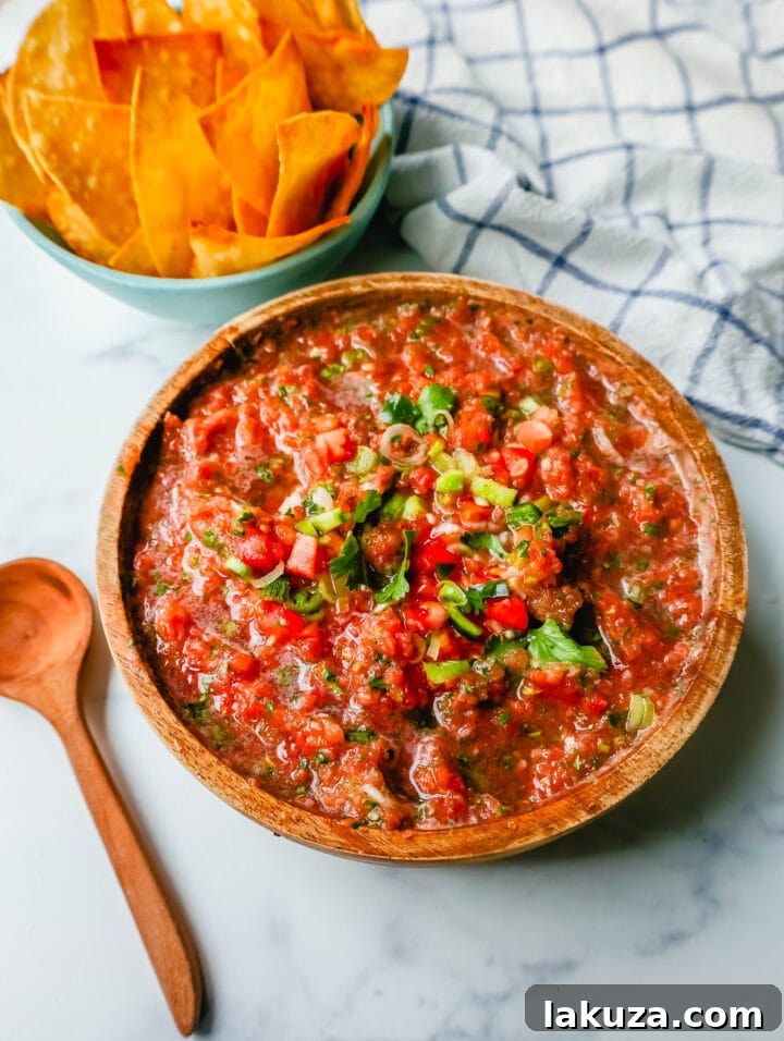 Best Homemade Restaurant-Style Salsa made with fresh tomatoes, cilantro, jalapeno, green onions, and a secret ingredient for an authentic Mexican flavor.