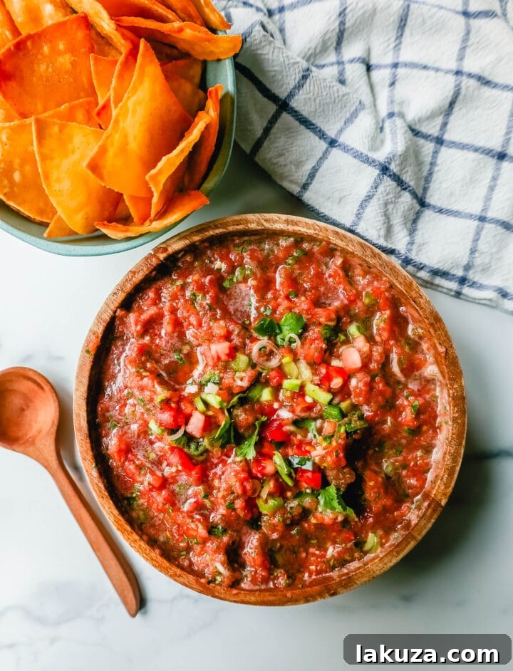 A bowl of delicious homemade restaurant-style salsa, ready to be served with chips.