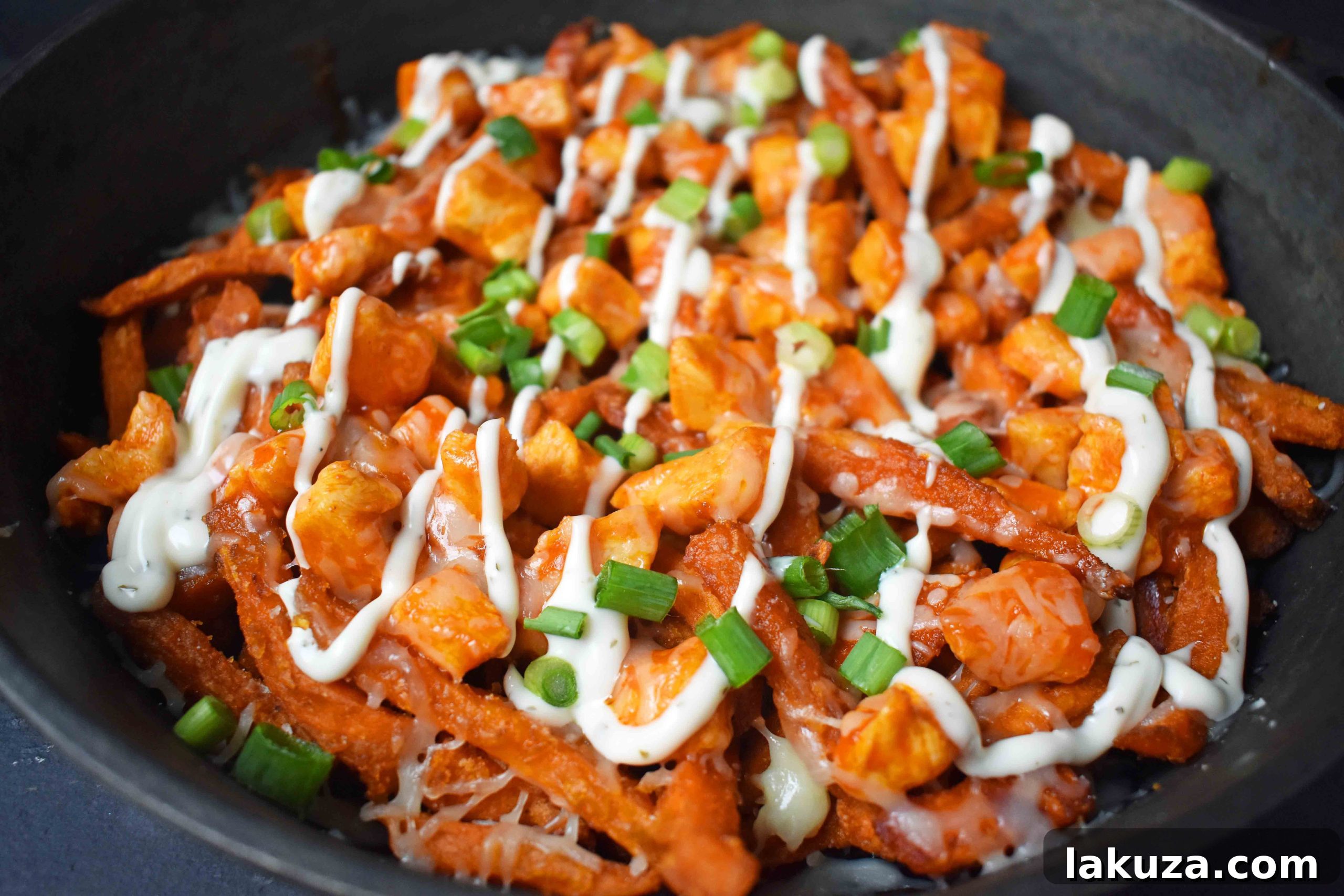 Buffalo Chicken Loaded Sweet Potato Fries 3 Modern Honey's Buffalo Chicken Sweet Potato Fries. A delicious blend of crispy sweet potato fries, seasoned buffalo chicken, gooey cheese, fresh green onions, and creamy ranch.