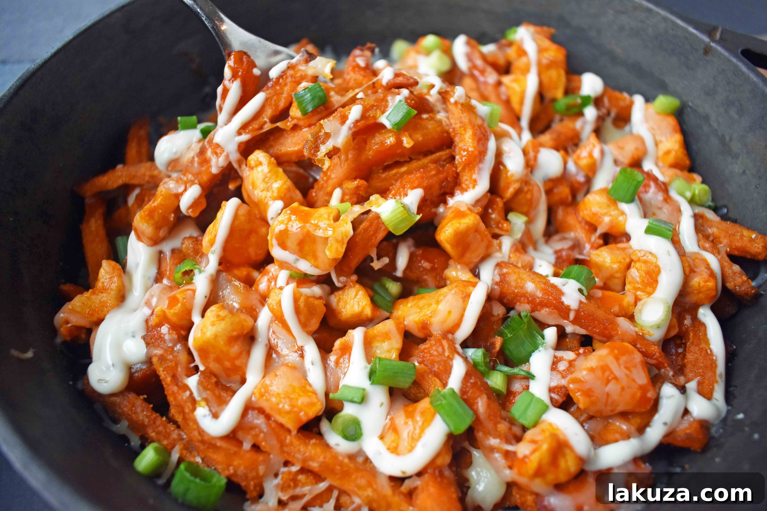 Buffalo Chicken Loaded Sweet Potato Fries 4 Buffalo Chicken Sweet Potato Fries with melted cheese, fresh green onions, and ranch. A perfect appetizer or snack.