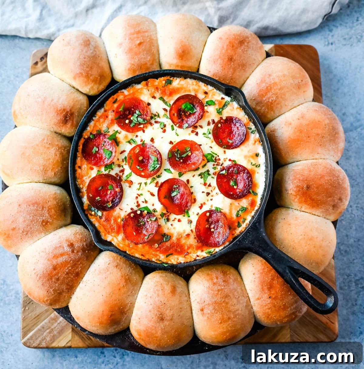 Close-up shot of hot, gooey Pepperoni Pizza Dip with melted cheese and crispy pepperoni, surrounded by fluffy garlic knots.