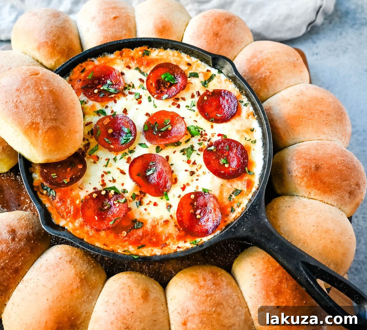 Ingredients for Pepperoni Pizza Dip laid out on a table, including cheeses, sauce, spices, pepperoni, and fresh basil.
