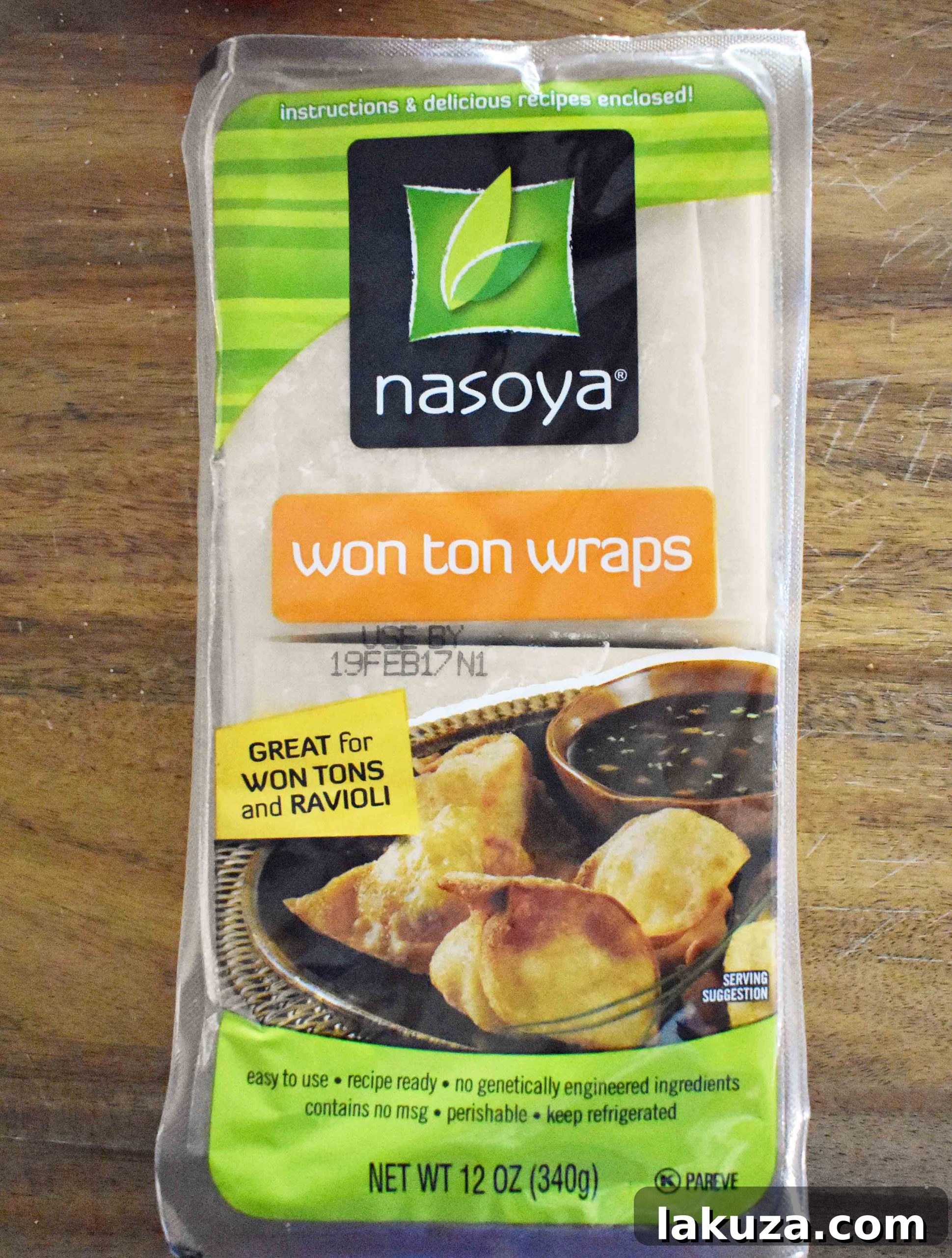 Asian Wonton Chicken Nachos. Fried wontons, pulled chicken, sriracha cream, cabbage mix, and sweet cilantro sauce. An Asian twist on nachos for the perfect party appetizer.