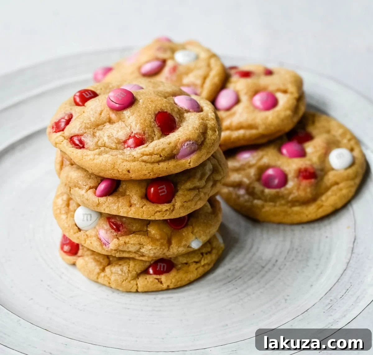 How to make the perfect Valentine's Day cookies. These soft and chewy Valentine's M&M Cookies have pops of pink, red, and white M&M's to make them not only delicious but festive and fun as well. You will love these Valentine's cookies!