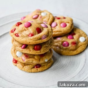 How to make the perfect Valentine's Day cookies. These soft and chewy Valentine's M&M Cookies have pops of pink, red, and white M&M's to make them not only delicious but festive and fun as well. You will love these Valentine's cookies!