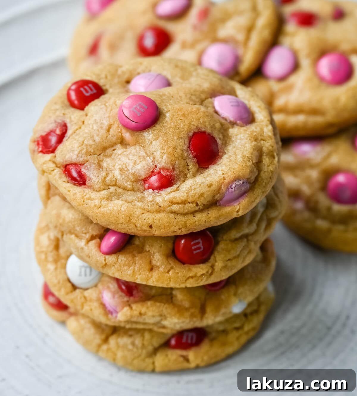 How to make the perfect Valentine's Day cookies. These soft and chewy Valentine's M&M Cookies have pops of pink, red, and white M&M's to make them not only delicious but festive and fun as well. You will love these Valentine's cookies!