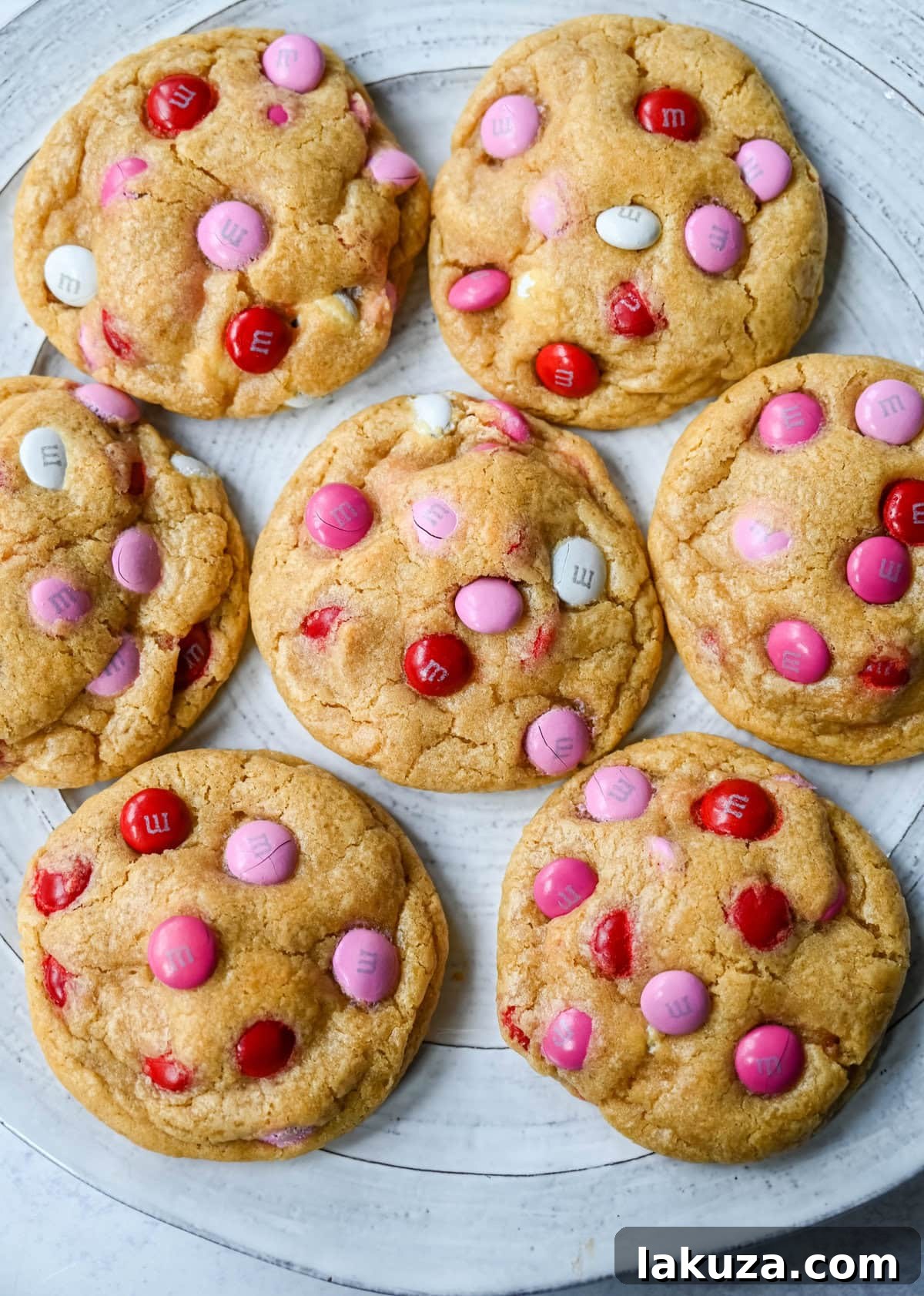 How to make the perfect Valentine's Day cookies. These soft and chewy Valentine's M&M Cookies have pops of pink, red, and white M&M's to make them not only delicious but festive and fun as well. You will love these Valentine's cookies!
