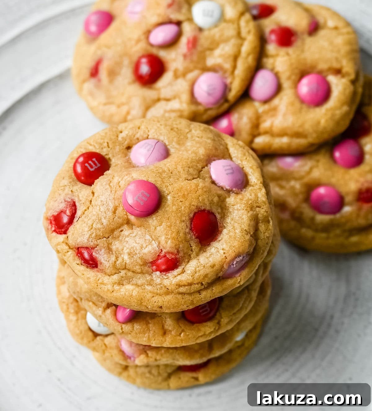 How to make the perfect Valentine's Day cookies. These soft and chewy Valentine's M&M Cookies have pops of pink, red, and white M&M's to make them not only delicious but festive and fun as well. You will love these Valentine's cookies!