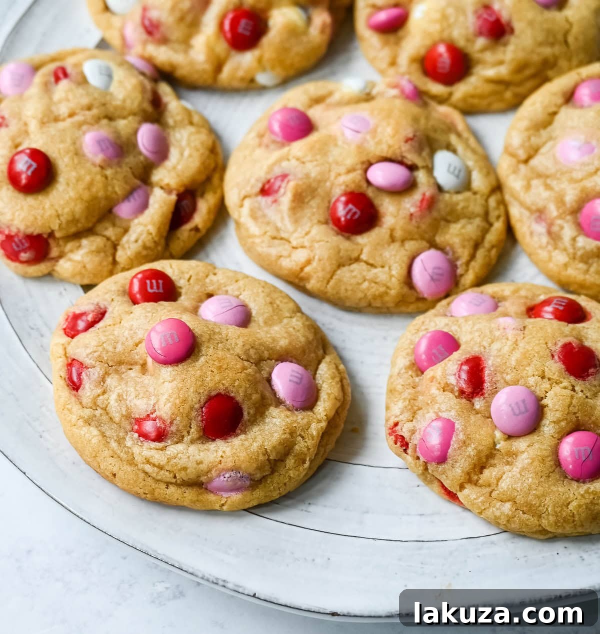 How to make the perfect Valentine's Day cookies. These soft and chewy Valentine's M&M Cookies have pops of pink, red, and white M&M's to make them not only delicious but festive and fun as well. You will love these Valentine's cookies!