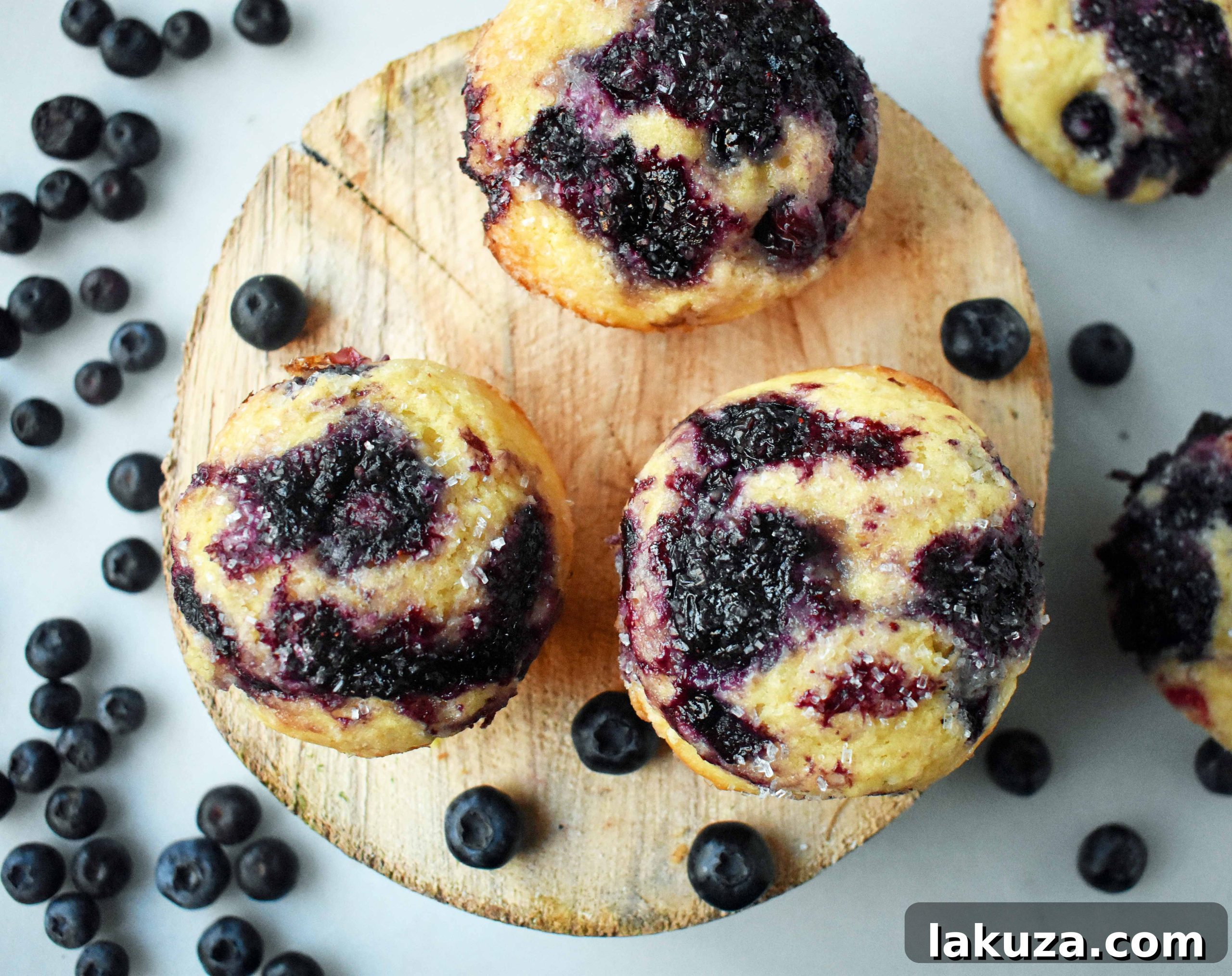Close-up of a perfectly baked blueberry muffin, showcasing its golden-brown top and visible blueberries.