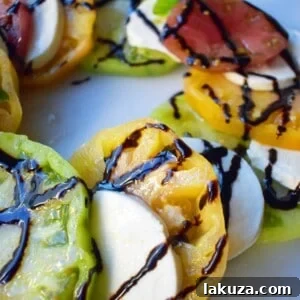 Radiant Heirloom Caprese 6 Heirloom Tomato Caprese Salad by Modern Honey. Garden Heirloom tomatoes layered with fresh mozzarella slices, extra virgin olive oil, balsamic glaze, salt, and fresh basil.