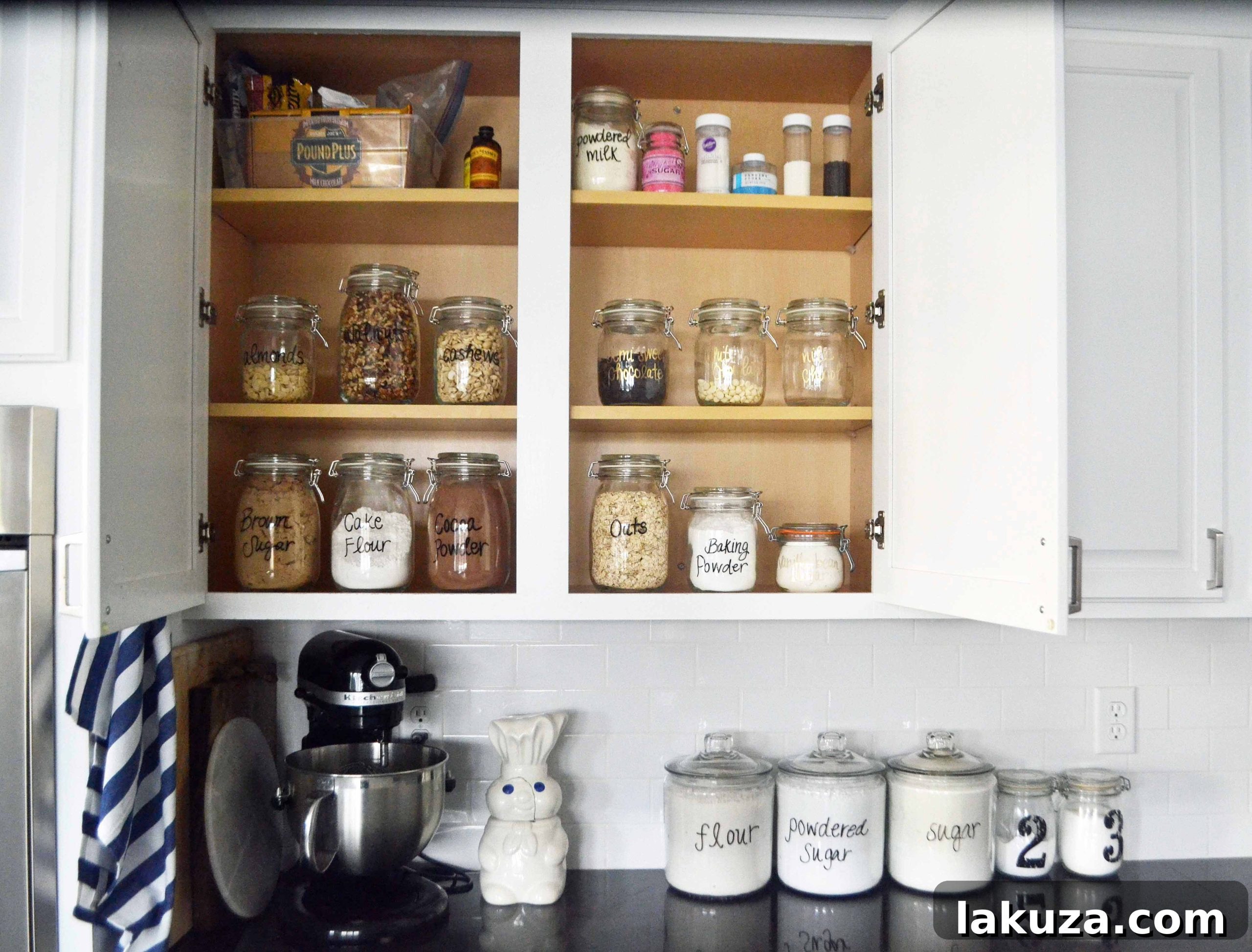 Another perspective of an organized baking cabinet, highlighting various baking ingredients and their storage solutions.