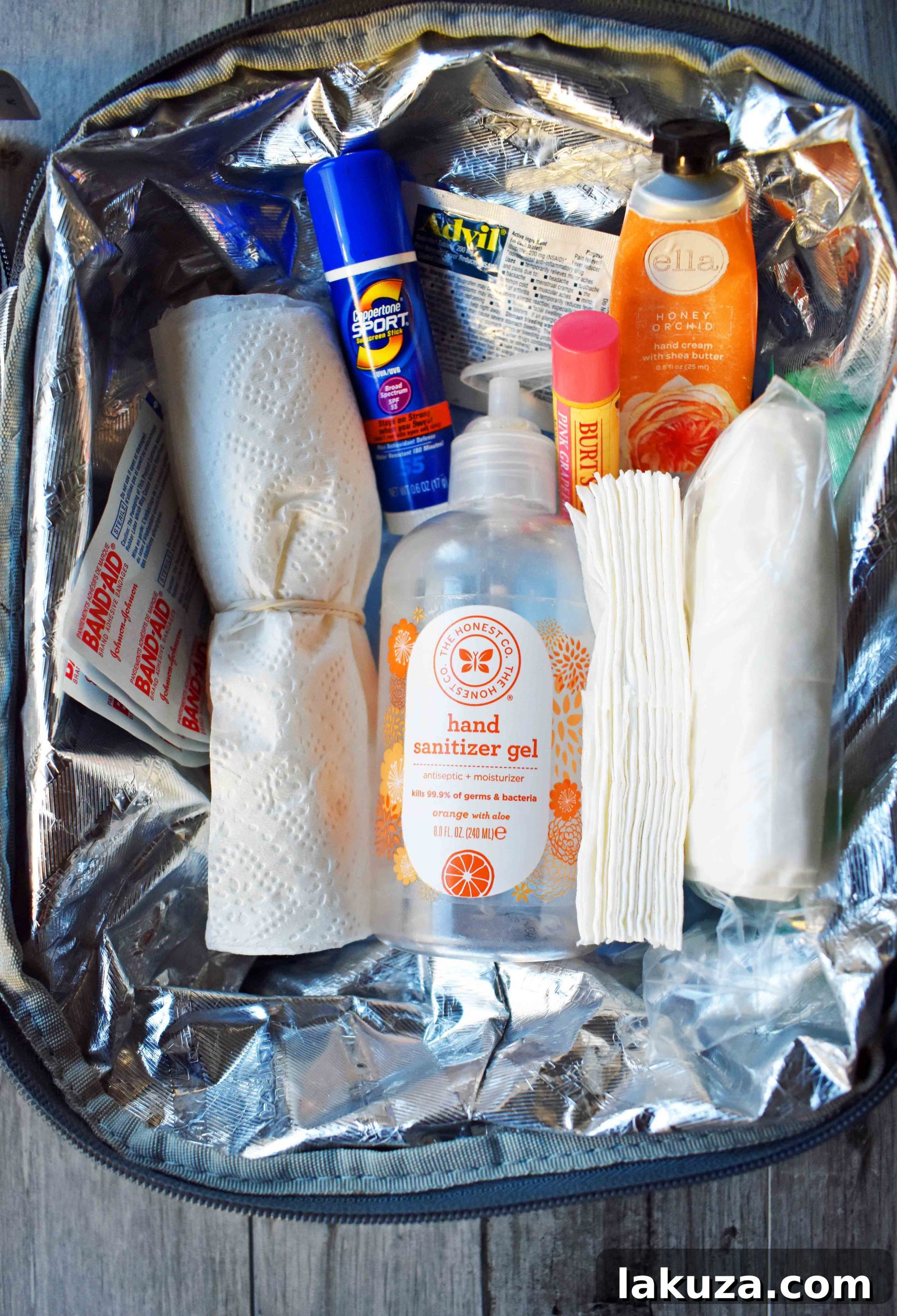 Road Trip Car Essential Kit organized in a small container. Essential items for family travel and emergencies. www.modernhoney.com