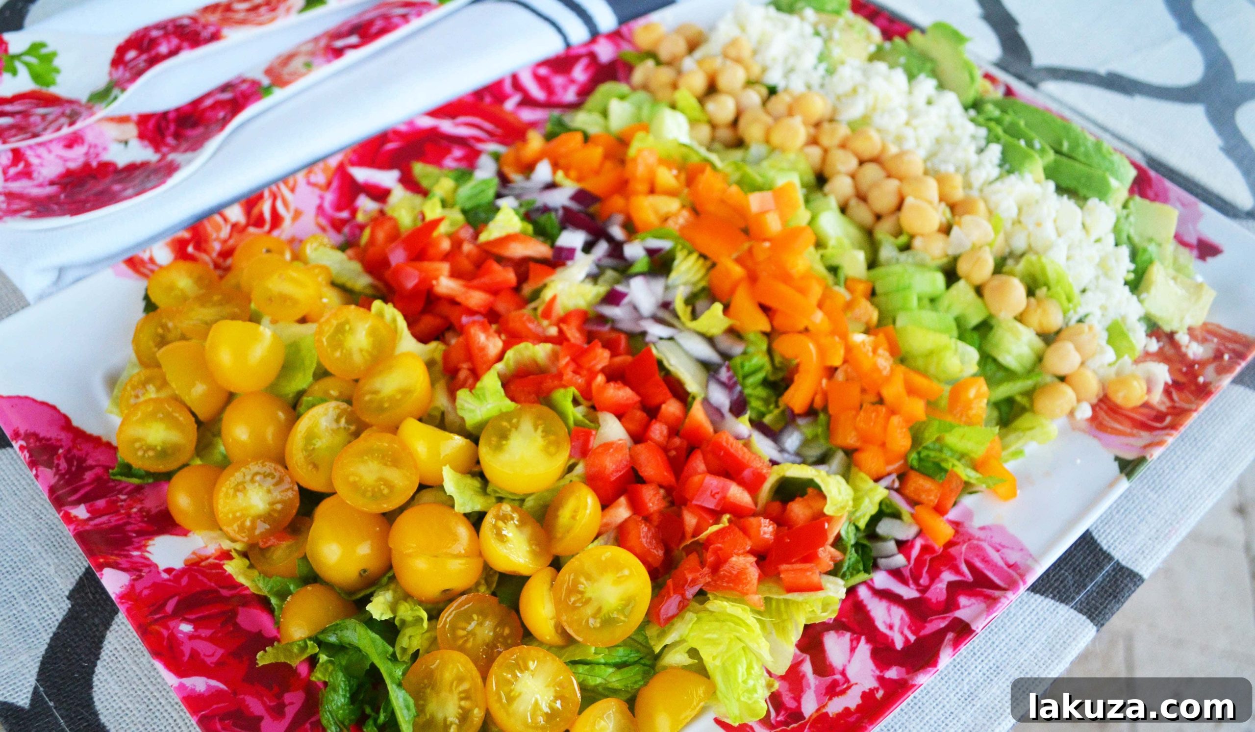 A closer look at the fresh ingredients for the Color Me Pretty Greek Salad, highlighting creamy avocado, plump chickpeas, and colorful bell peppers.