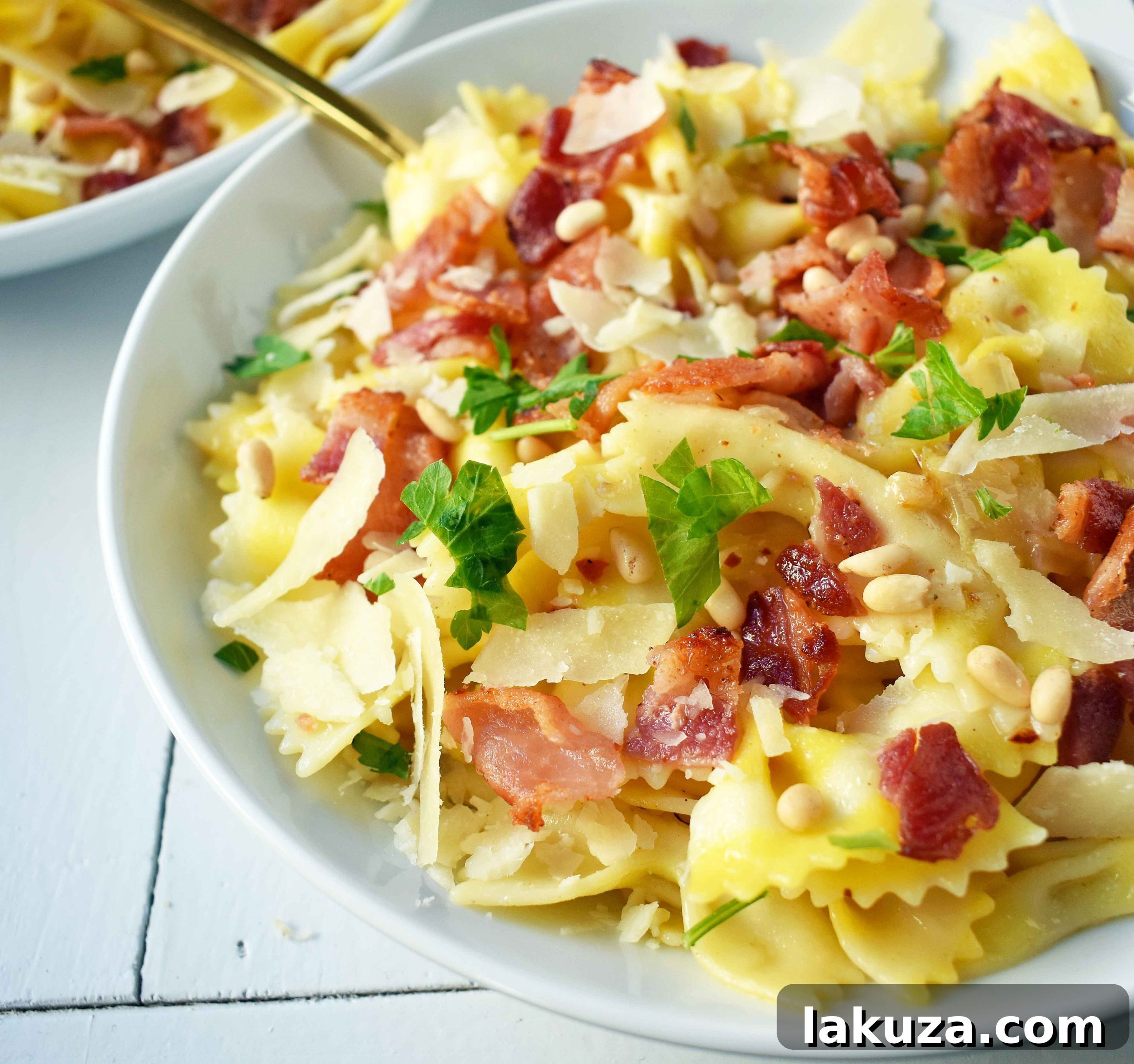 Bright Lemon Garlic Pasta with Crispy Bacon 4 A close-up view of Lemon Garlic and Crispy Bacon Farfalle, highlighting the perfectly cooked pasta, caramelized onions, minced garlic, and vibrant lemon zest. The texture of the crispy bacon and pine nuts is visible, making it an appealing savory and fresh dish.