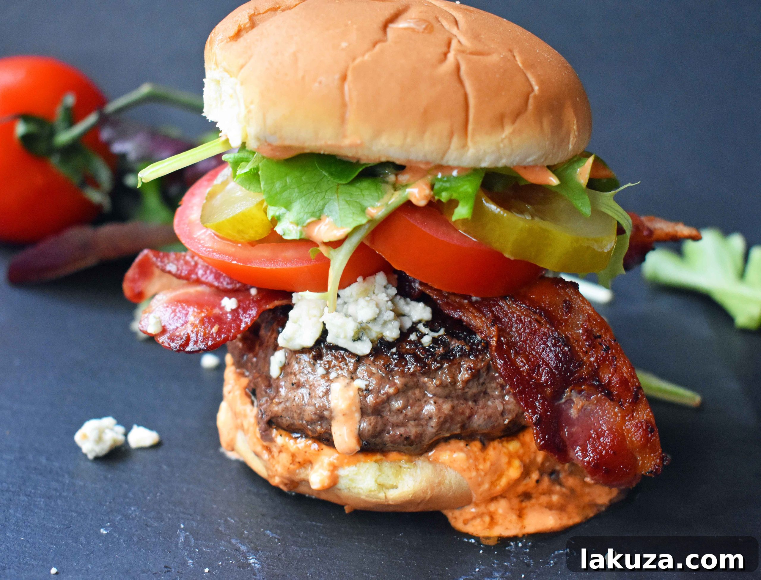 The Wyrmbane Burger 4 Dragonslayer Burger. Beef with blue cheese, crispy bacon, juicy tomatoes, crunchy pickles, spring mix, and buffalo ranch sauce. A full recipe card is included.