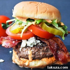 The Wyrmbane Burger 5 Dragonslayer Burger. Beef with blue cheese, crispy bacon, juicy tomatoes, crunchy pickles, spring mix, and buffalo ranch sauce. Learn to make this incredible burger.