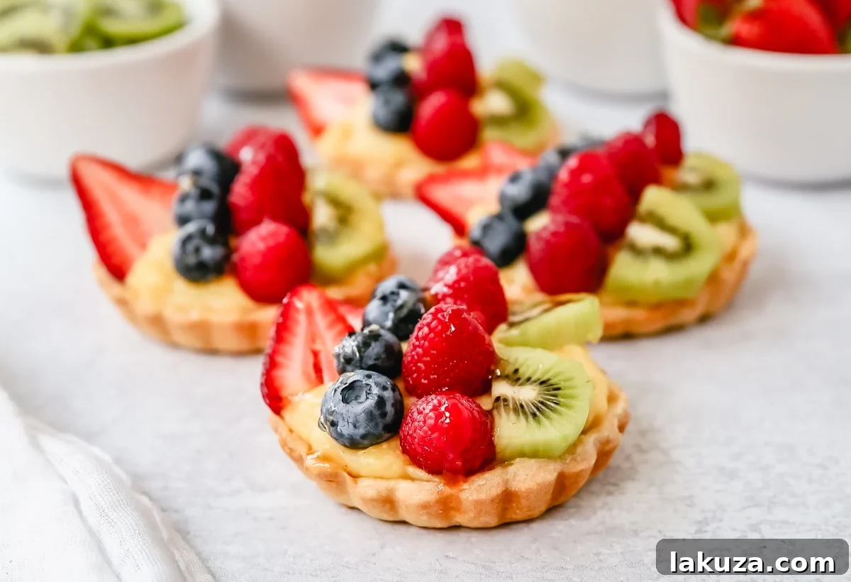 Classic French Fruit Tart with flaky butter crust, creamy vanilla bean pastry cream, and vibrant fresh fruit topping.