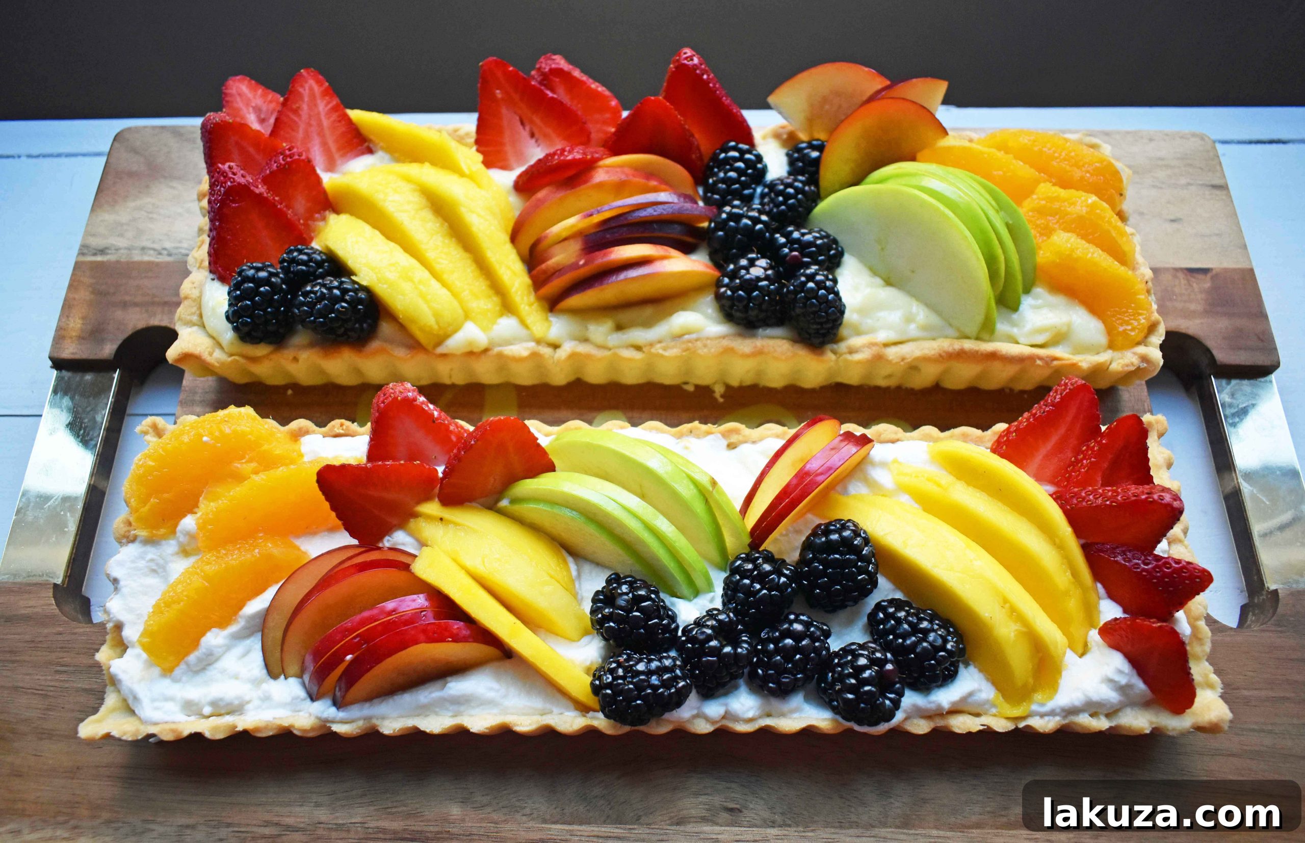 Beautifully composed Fresh Fruit Tart with Vanilla Pastry Cream, artfully arranged on a serving platter, ready to be enjoyed.