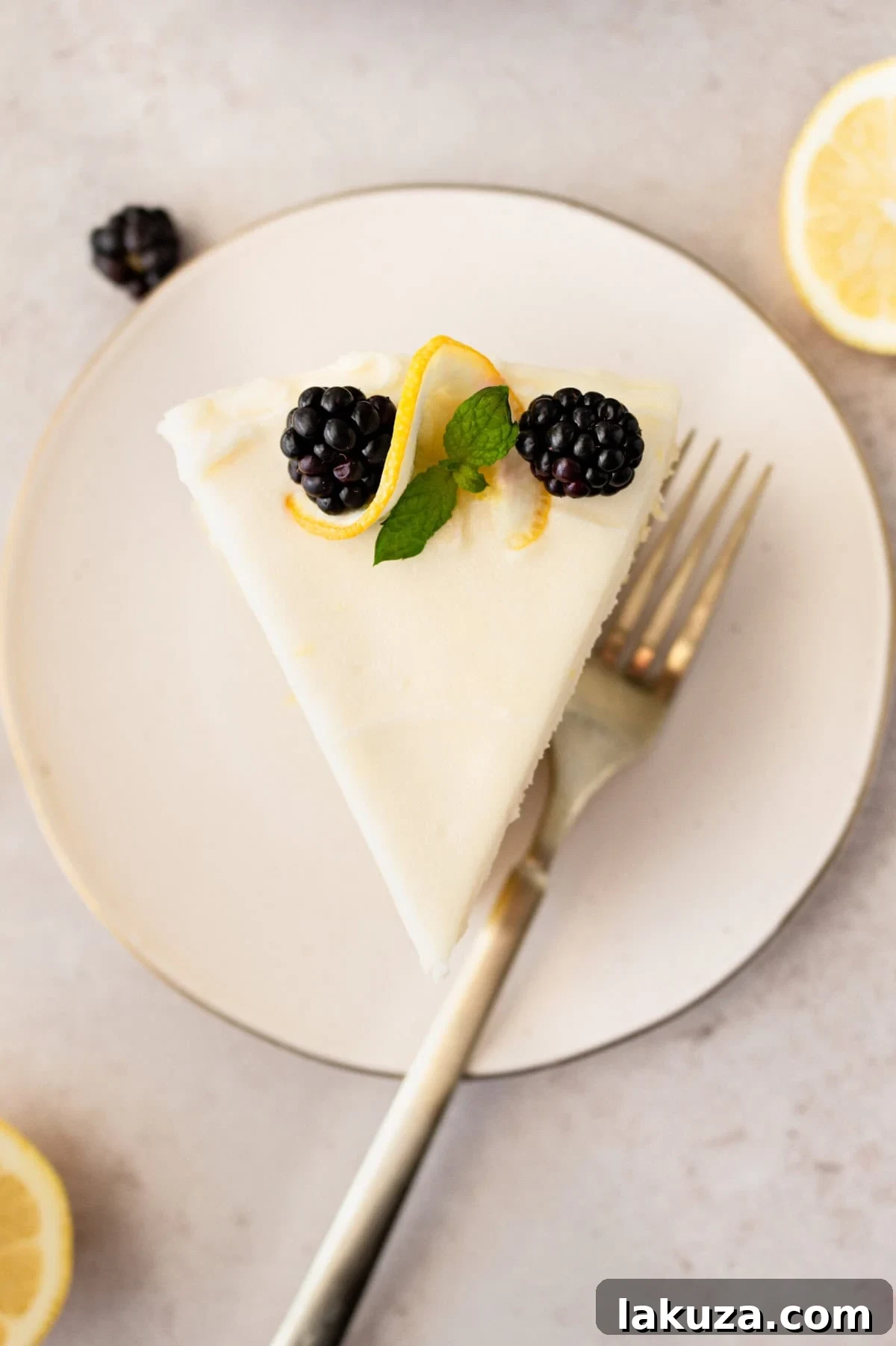 A rustic cutting board with several slices of Italian Lemon Olive Oil Cake, showcasing its texture and the creamy frosting, ready for serving.