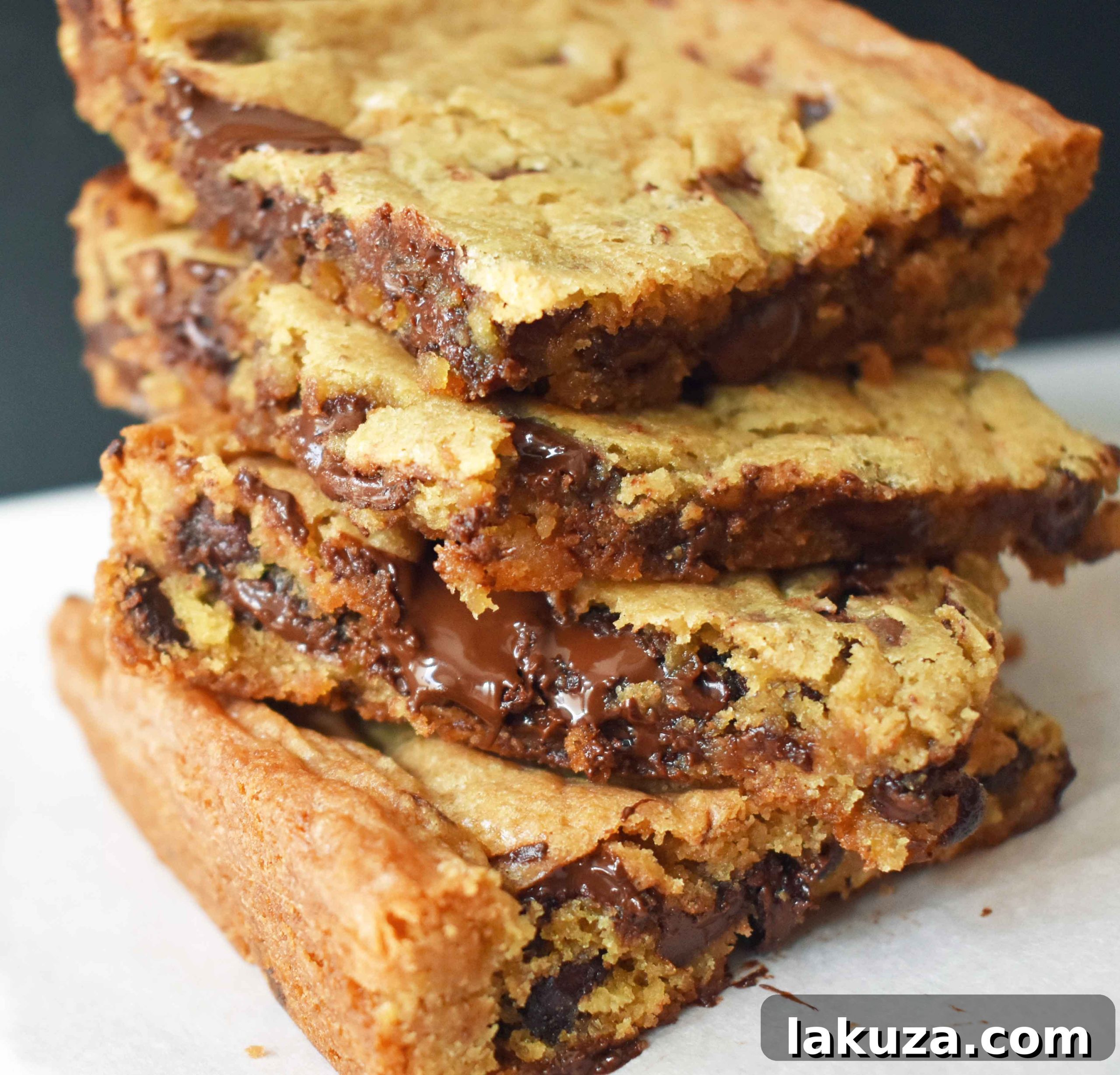 Irresistible Chocolate Chip Bars 2 Deliciously gooey chocolate chip cookie bars in a baking pan, ready to be cut into squares. A classic buttery chocolate chip cookie bar recipe.