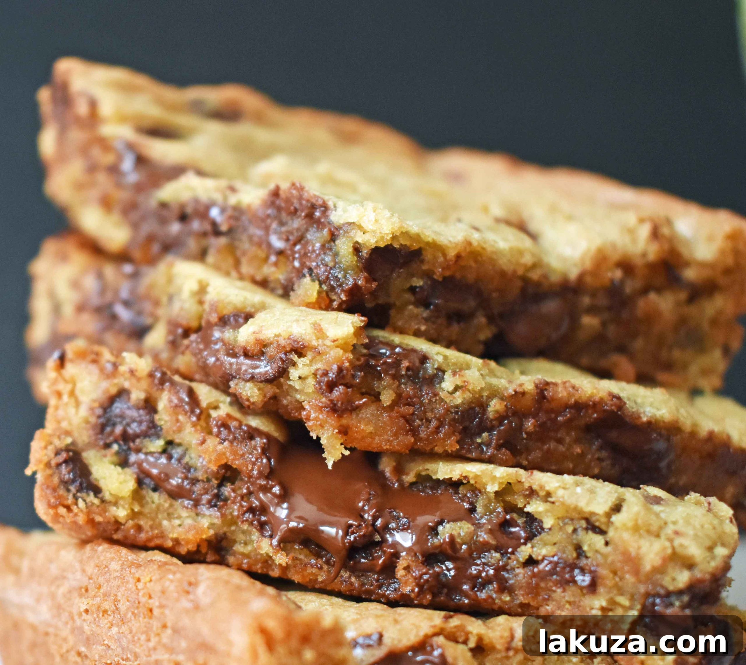 Irresistible Chocolate Chip Bars 3 Close-up shot of a single perfectly baked chocolate chip cookie bar, showcasing its golden edges and melted chocolate chips.
