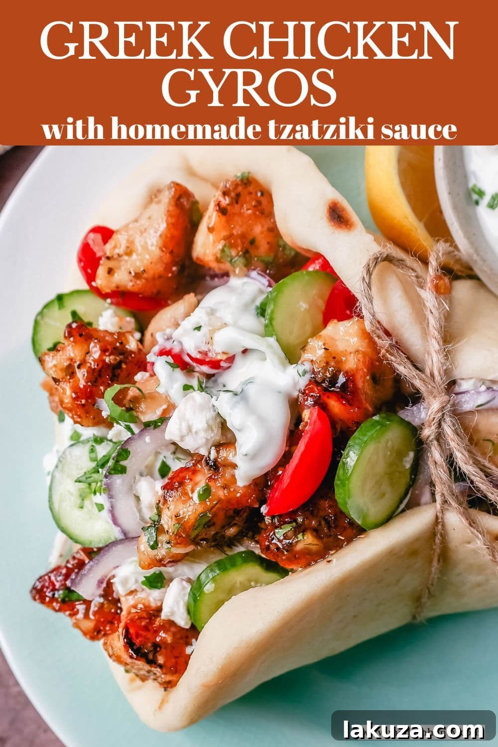 Final plated shot of a single Greek Chicken Gyro, showcasing the tender chicken, creamy tzatziki, and fresh Greek salad on pita.