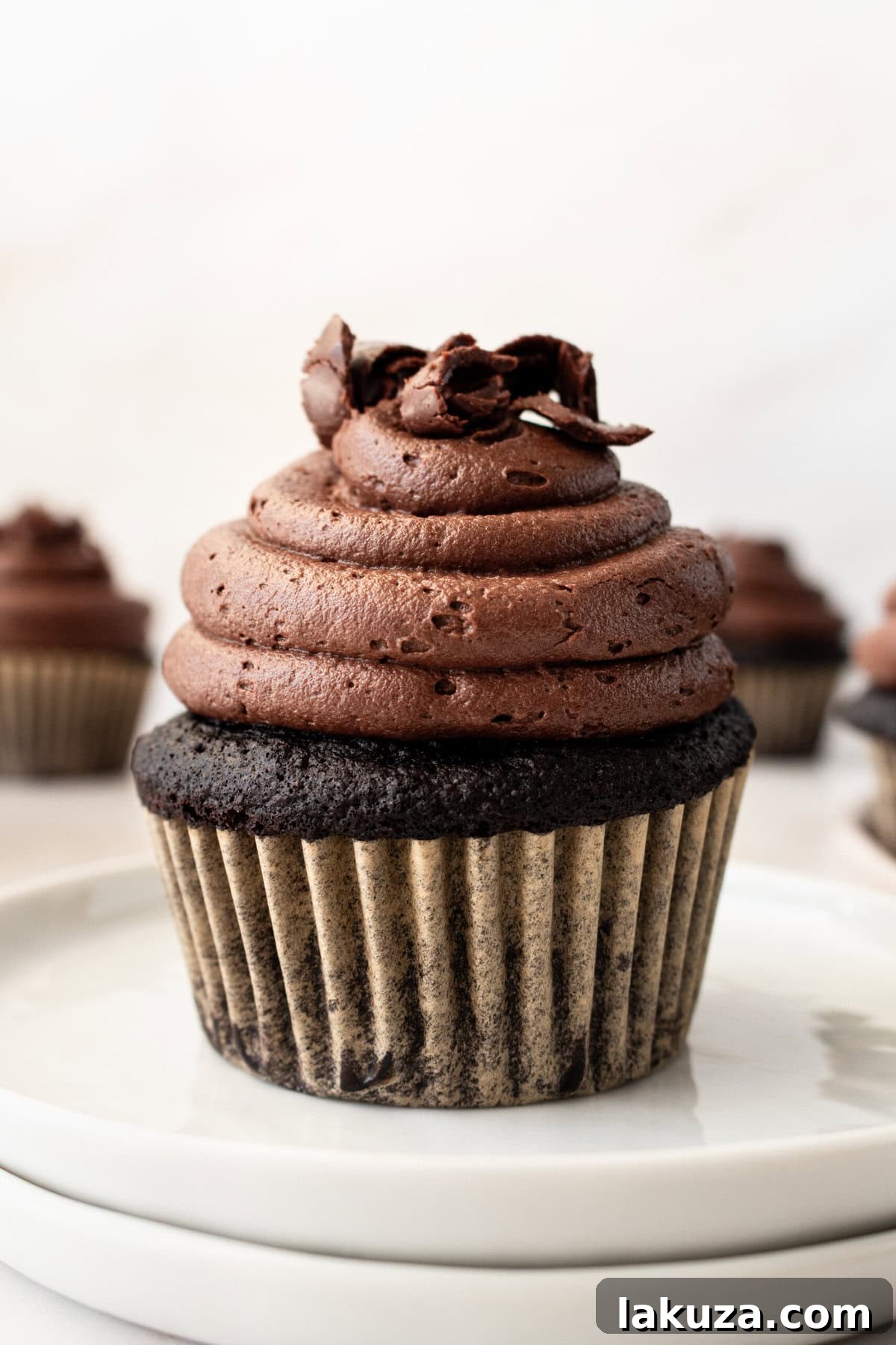 Decadent Chocolate Cupcakes 2 A perfectly frosted rich chocolate cupcake, showcasing the moist crumb and decadent chocolate frosting, ready to be enjoyed.