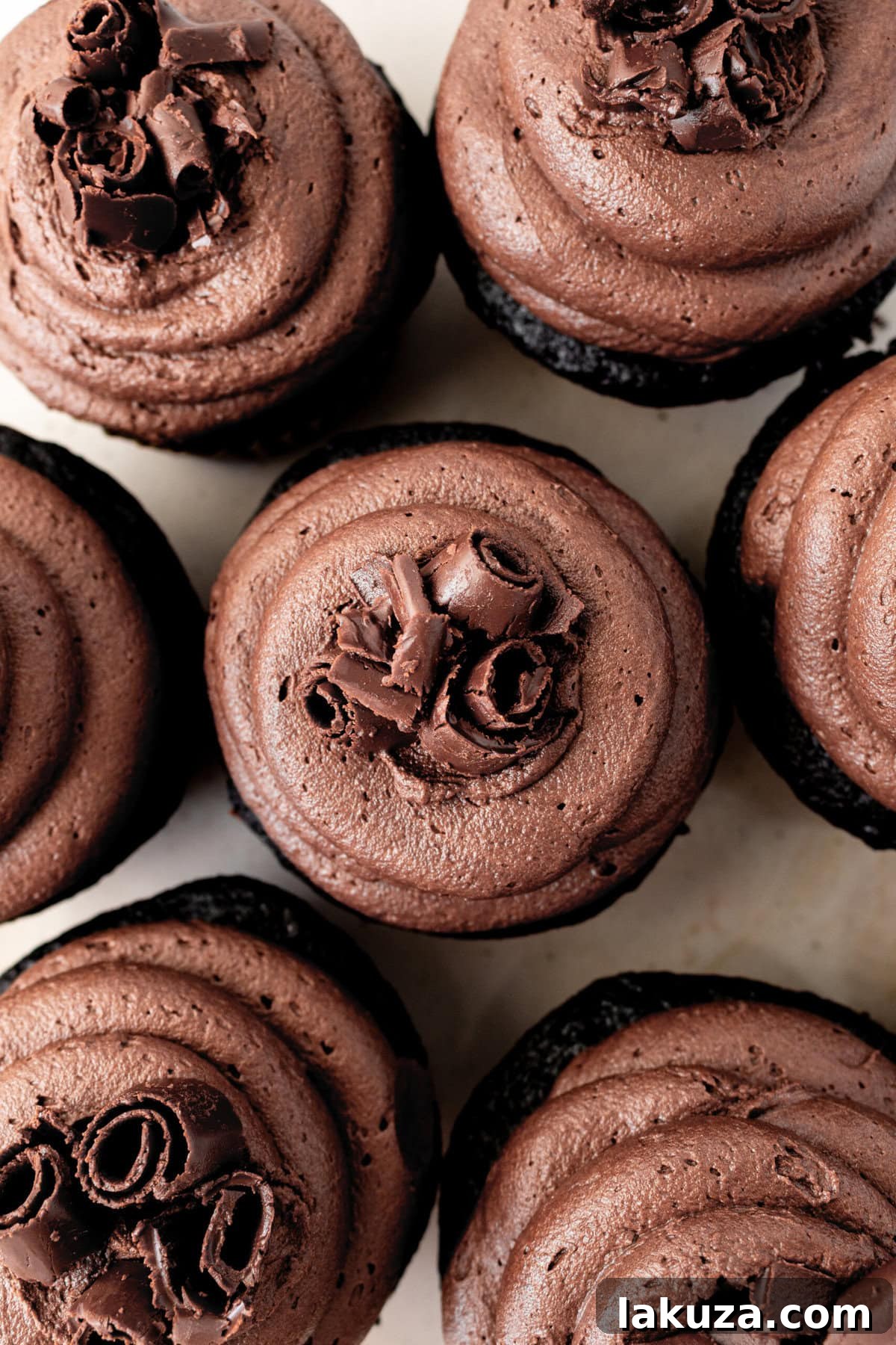 Decadent Chocolate Cupcakes 4 A close-up shot of several frosted chocolate birthday cupcakes, garnished with chocolate shavings and ready for a celebration.