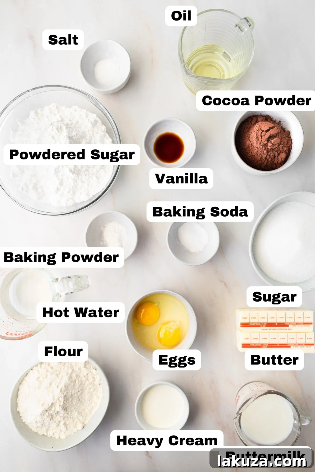 Decadent Chocolate Cupcakes 5 A flat lay photograph showcasing all the key ingredients needed to bake the ultimate chocolate cupcakes, including flour, sugar, cocoa powder, butter, eggs, milk, and vanilla extract.