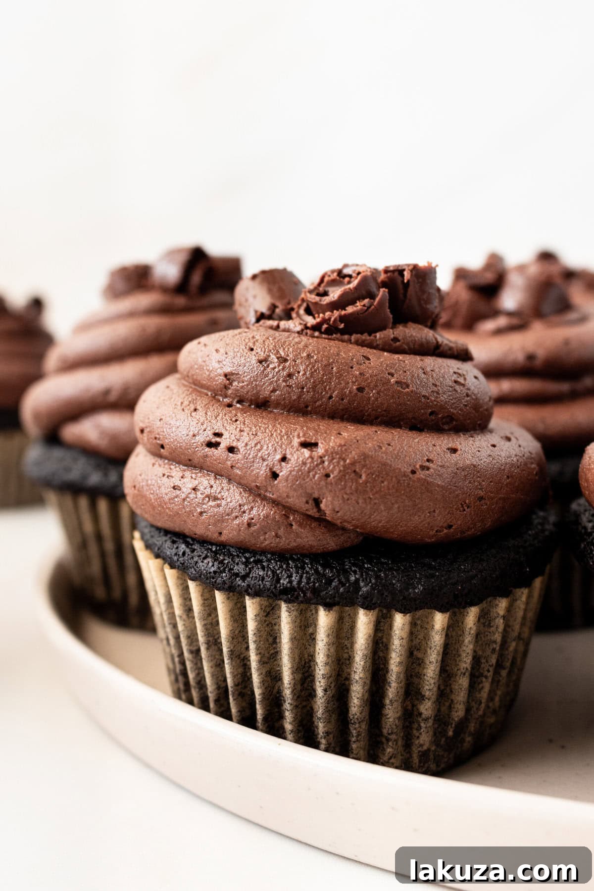 Decadent Chocolate Cupcakes 6 Freshly baked, unfrosted chocolate cupcakes cooling in muffin tins, awaiting their luscious chocolate buttercream.