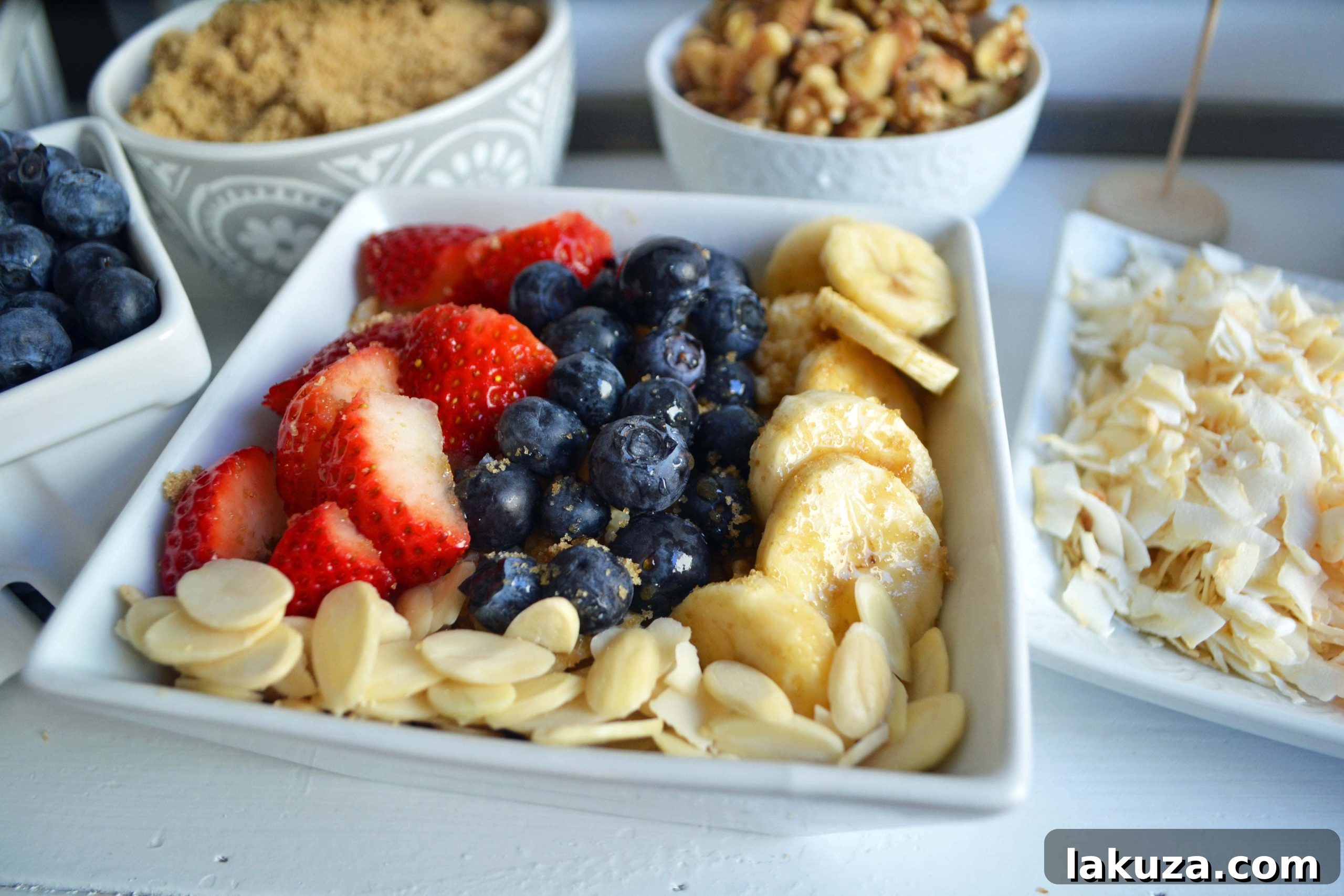 Craft Your Oat Creation 15 Close-up of an oatmeal toppings bar by Modern Honey, showing fresh berries and nuts in decorative bowls.