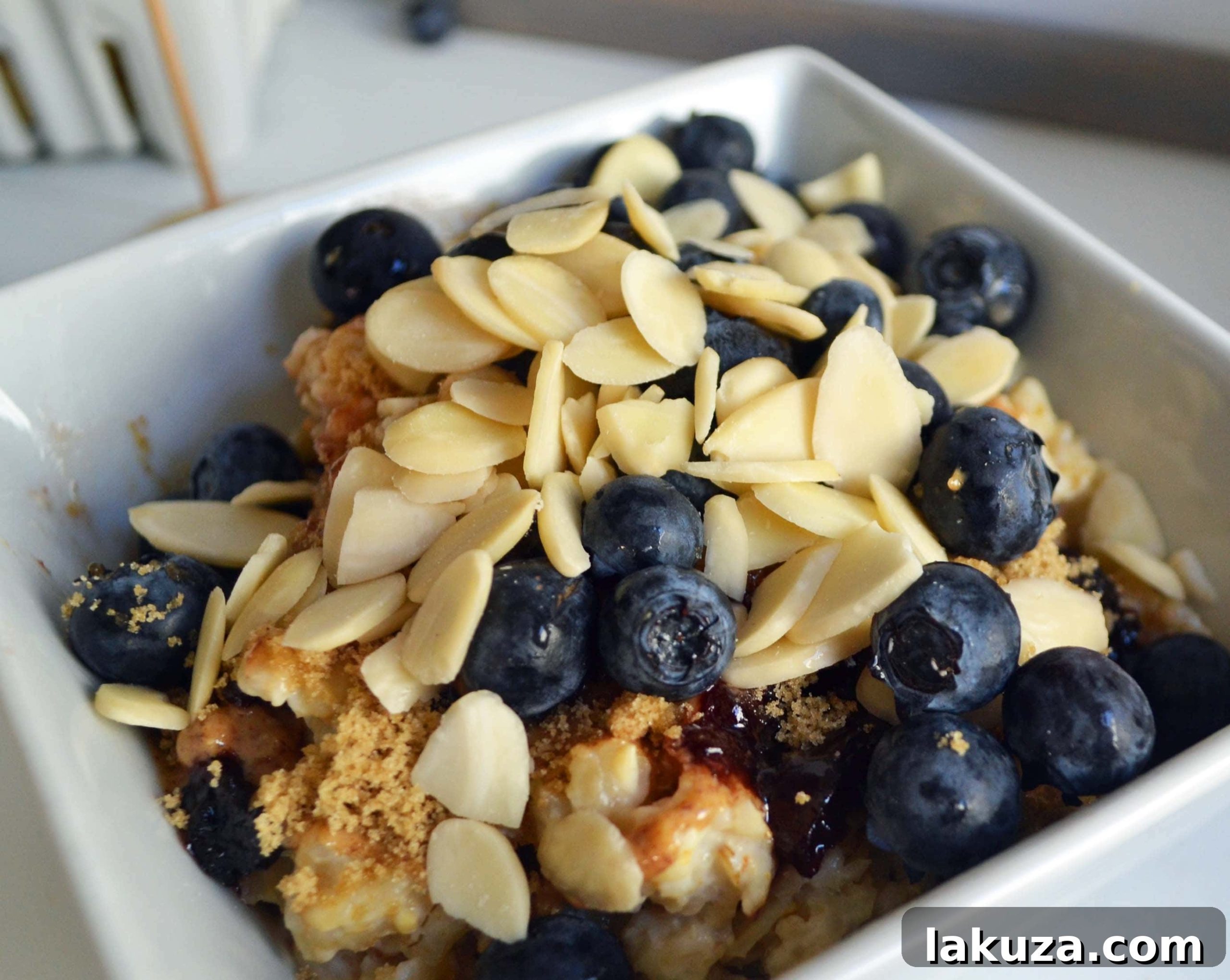 Craft Your Oat Creation 18 A close-up of fresh fruit toppings, including berries and bananas, arranged for an oatmeal bar.