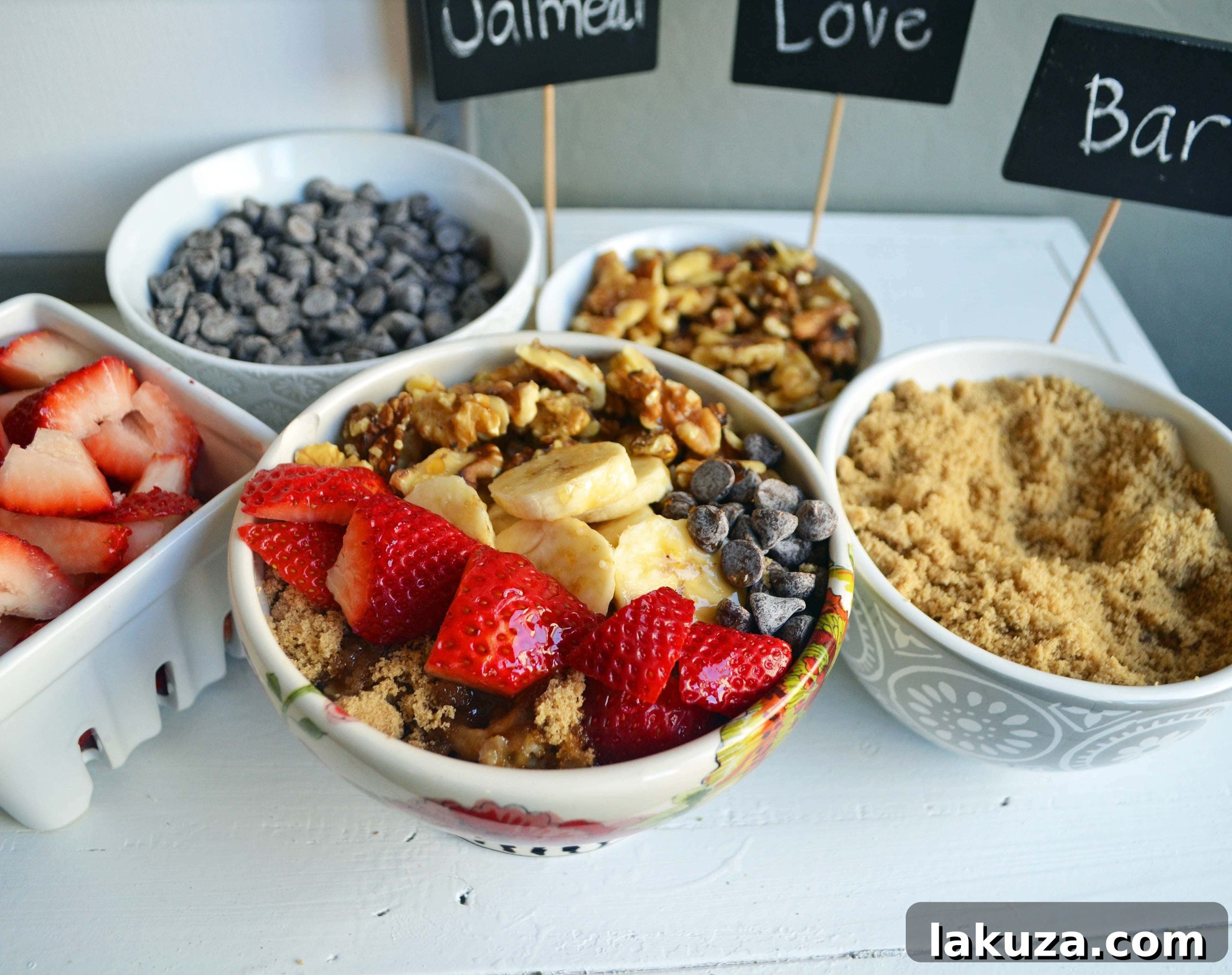 Craft Your Oat Creation 20 A large, inviting oatmeal bar display with various fresh and dried fruit toppings, nuts, and sweet sauces.