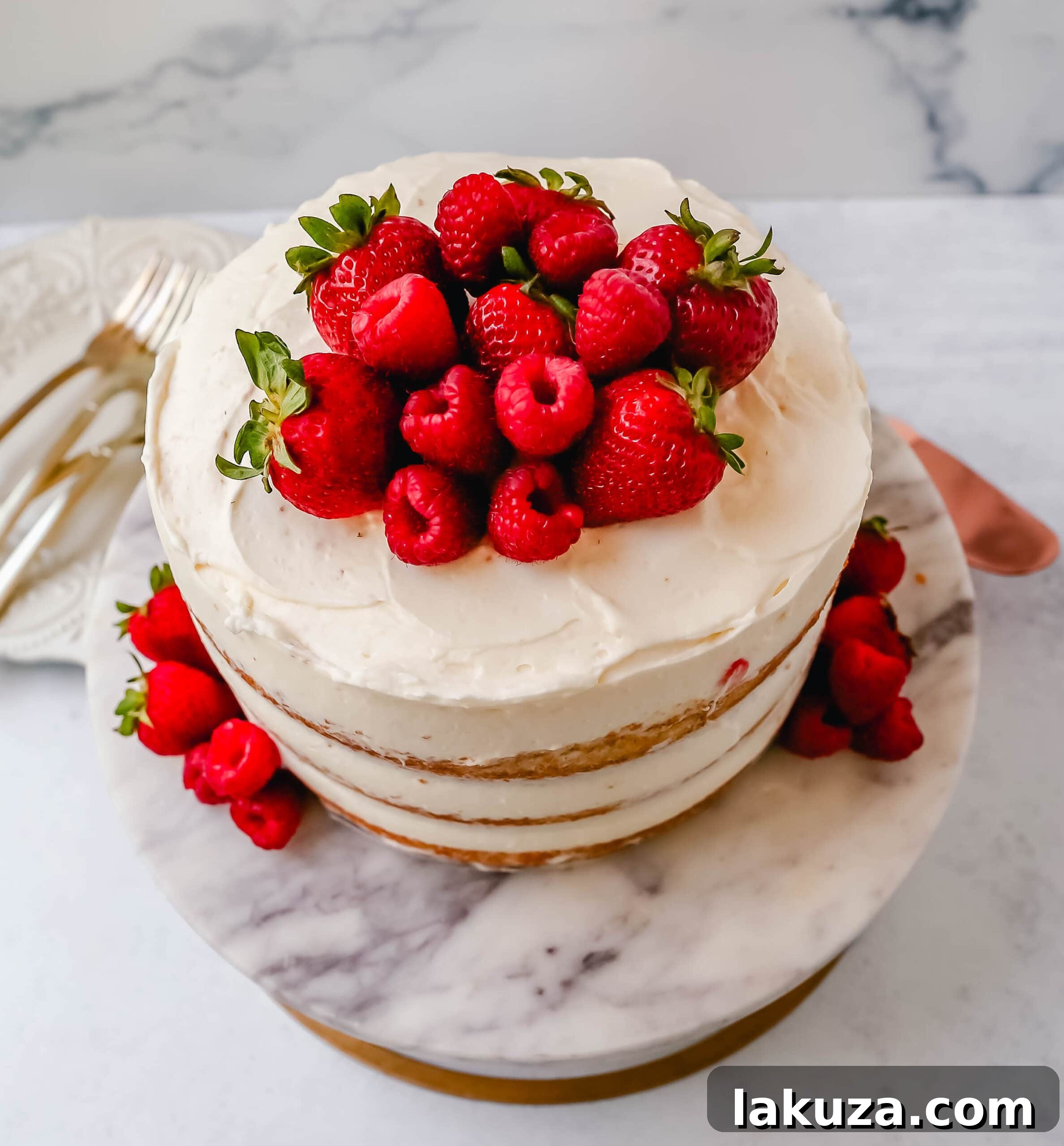 Berry Chantilly Cake 16 Another perspective of a slice of homemade yellow cake with fluffy cream cheese whipped cream frosting and fresh berries.