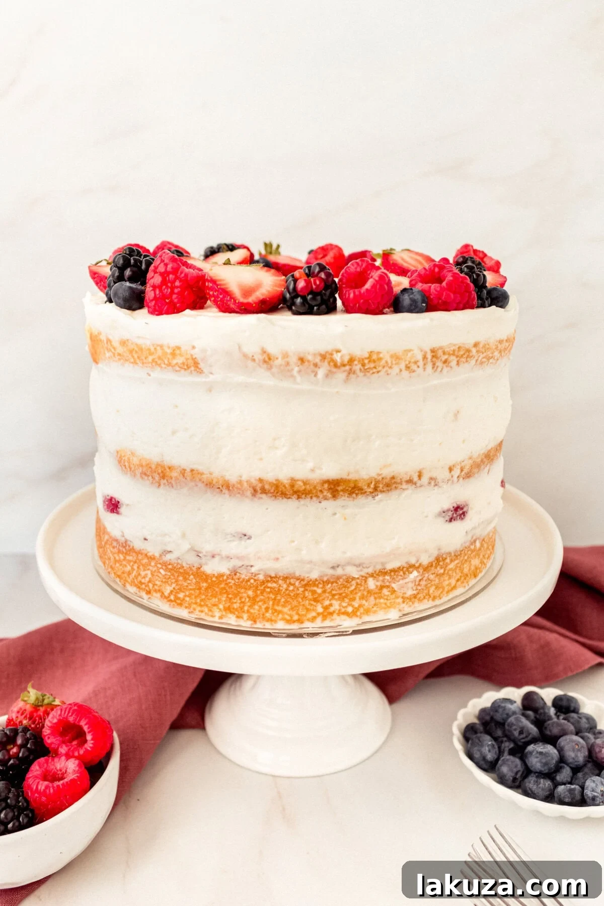 Berry Chantilly Cake 3 A high-angle shot showcasing the moist yellow cake layers, the rich Chantilly cream frosting, and the vivid fresh berries of a homemade Berry Chantilly Cake.