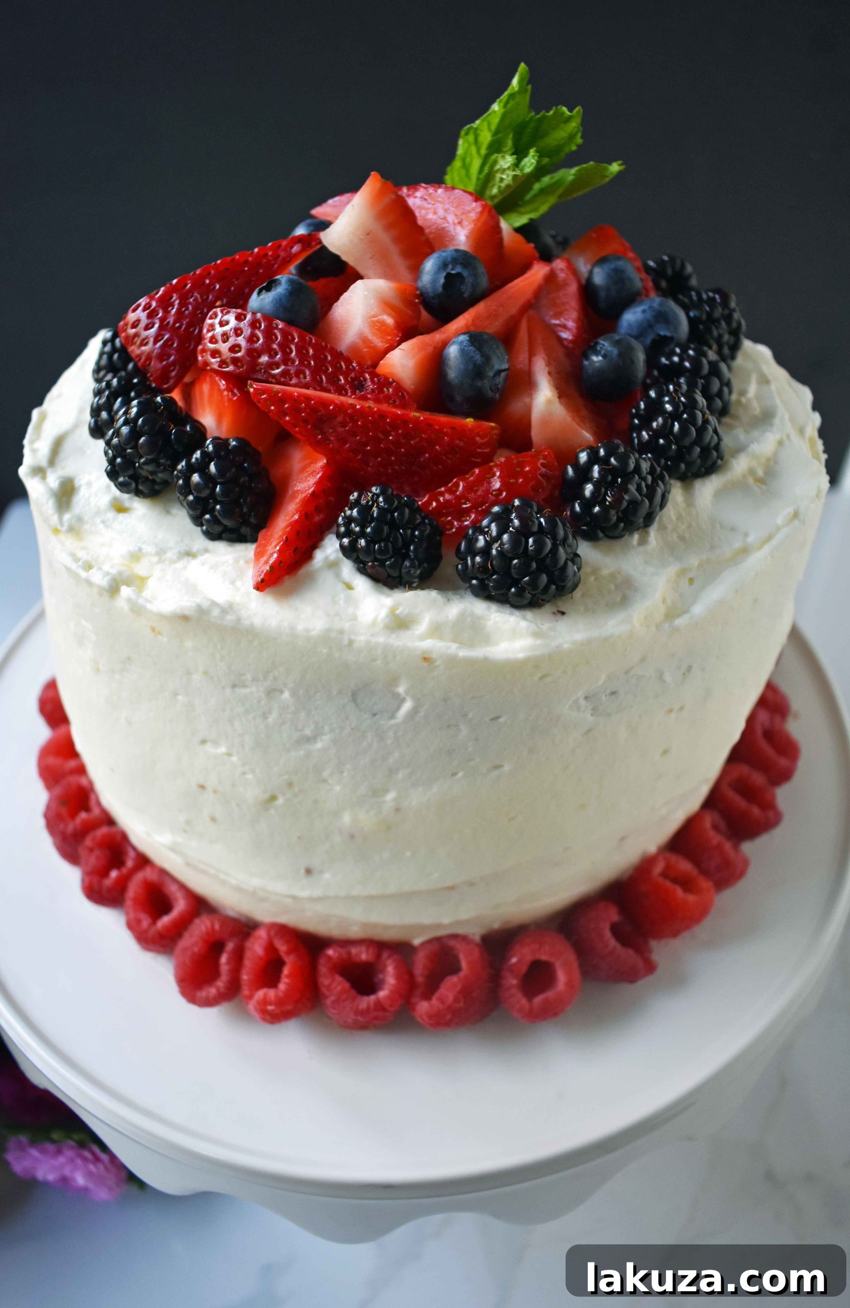 Berry Chantilly Cake 24 A close-up shot of the Berry Chantilly Cream Cake, emphasizing the vibrant fresh berries and the soft, creamy frosting texture.