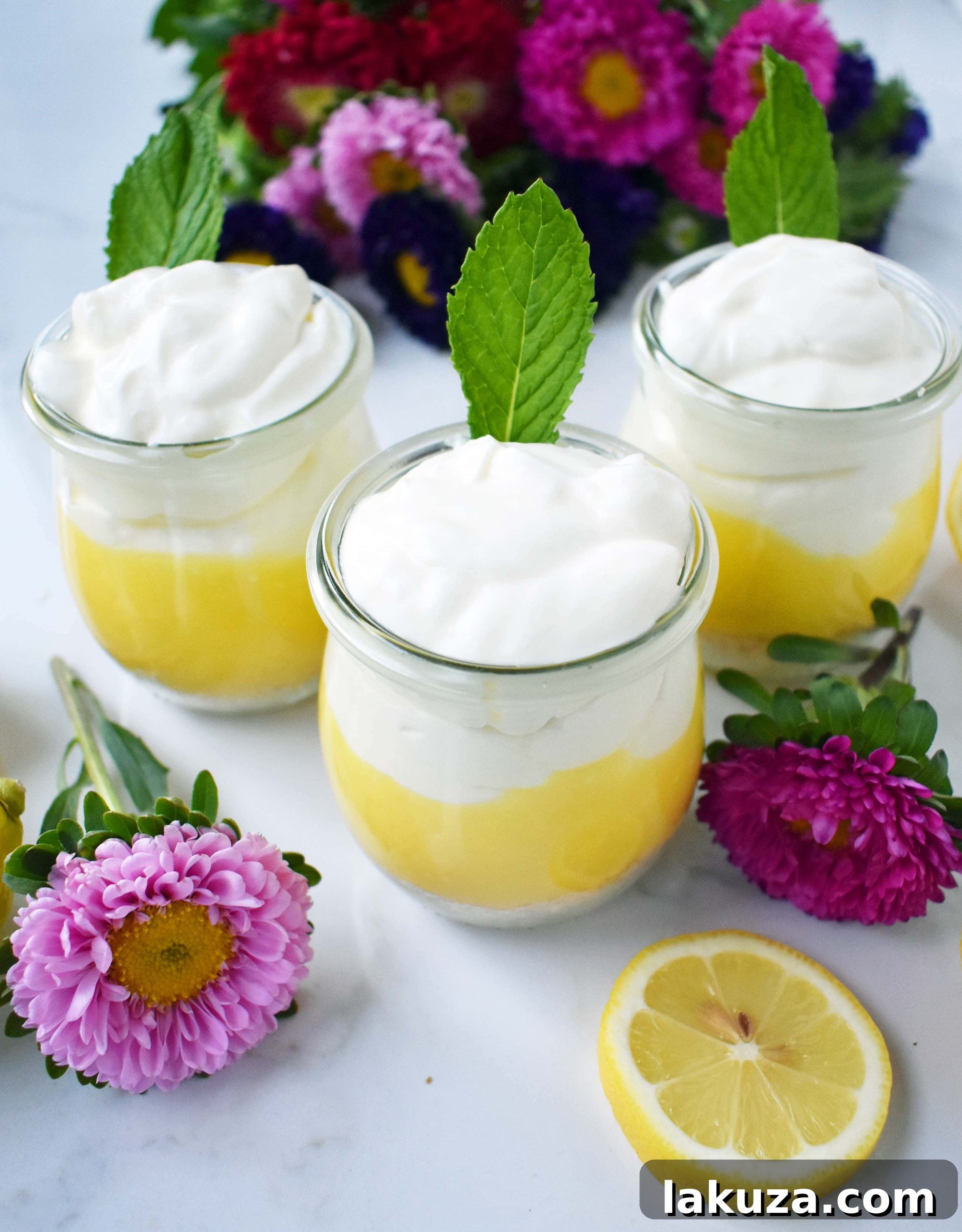 Sunshine Lemon Parfait Jars 4 Layers of homemade lemon curd, crunchy cookie crust, and fluffy vanilla cream cheese topping visible in a Lemon Cream Parfait Pie Jar, ready for serving at a party or special occasion.