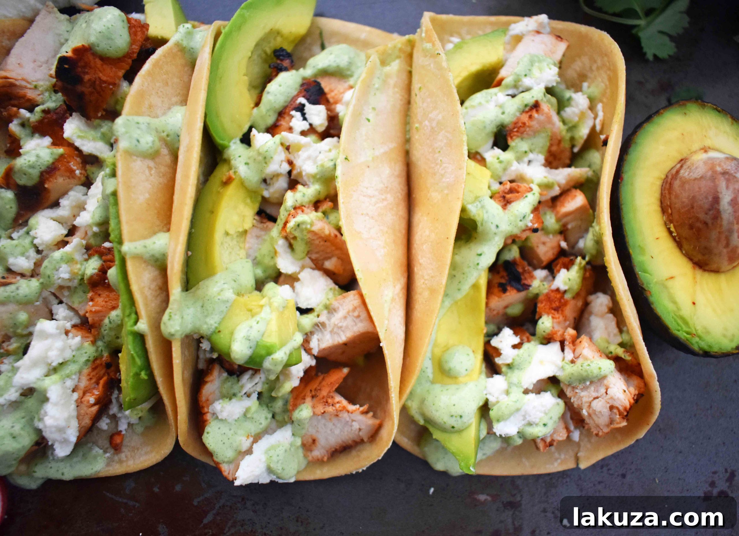Grilled Chicken Tacos with Roasted Poblano Lime Crema 3 Close-up of vibrant Grilled Chicken Tacos showcasing chili-lime chicken, creamy poblano sauce, and fresh garnishes.