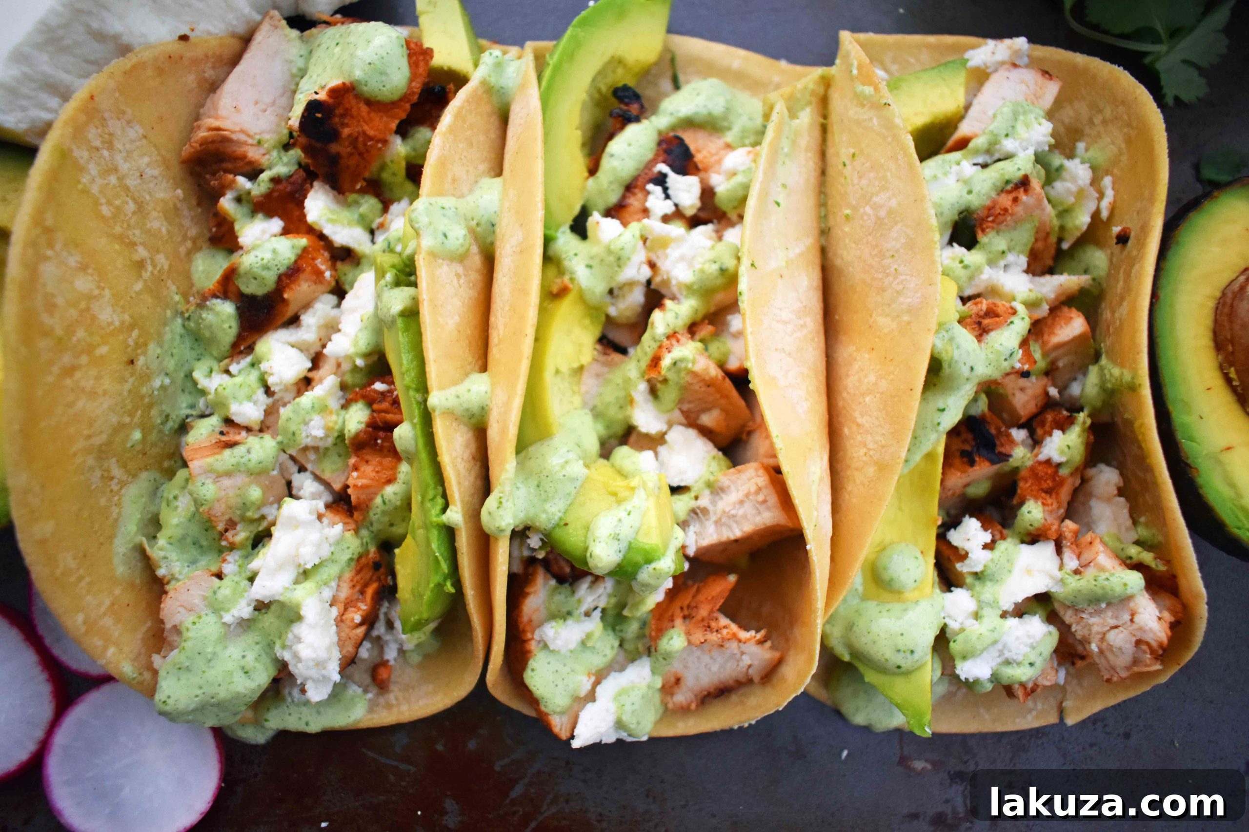 Grilled Chicken Tacos with Roasted Poblano Lime Crema 4 An array of ingredients for homemade grilled chicken tacos, including marinated chicken and poblano peppers.