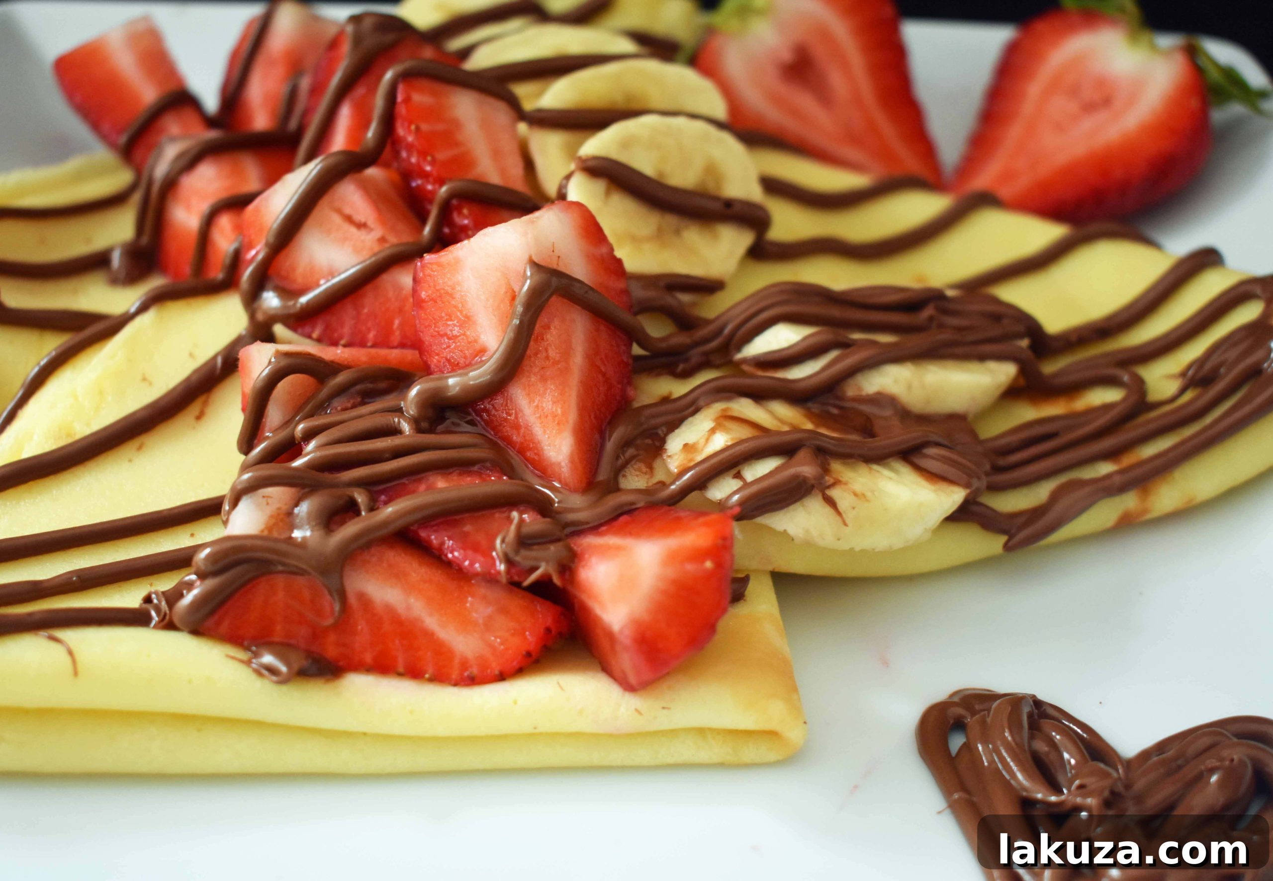Perfect Crepes Recipe with Nutella and Strawberries. Buttery French crepes that melt-in-your-mouth. A list of crepe topping ideas and where to buy the best crepe pans. Modern Honey.