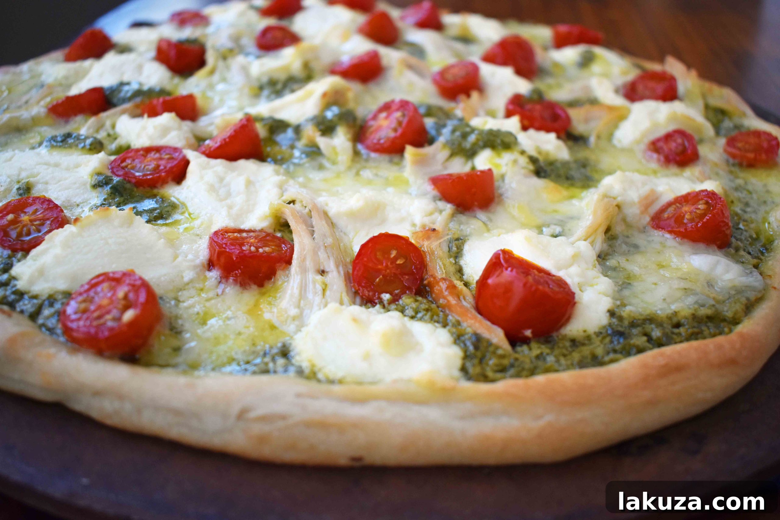 Homemade Chicken Pesto Pizza with a golden crust and melted cheese.
