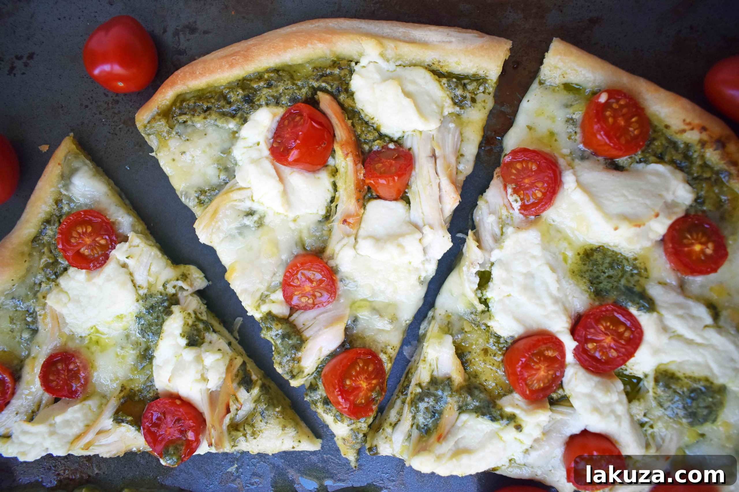 Cooked Chicken Pesto Pizza sliced and ready to serve.