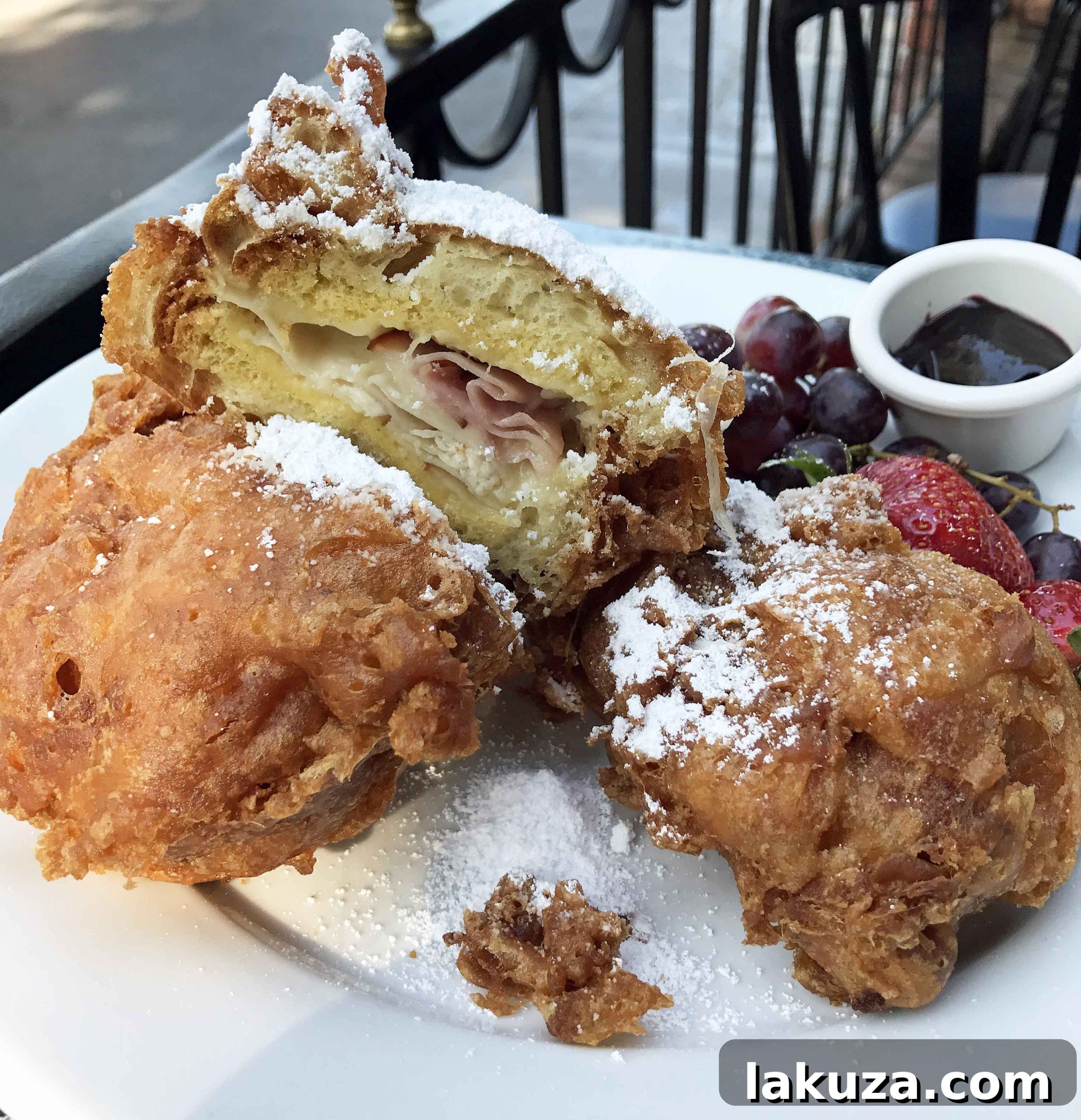 Disneyland's Gastronomic Gold: Essential Eats & Sweet Treats 4 The iconic Monte Cristo Sandwich at Disneyland, a must-try fried delight with turkey, ham, and Swiss cheese, served with berry purée. Find it at Cafe Orleans or Blue Bayou.