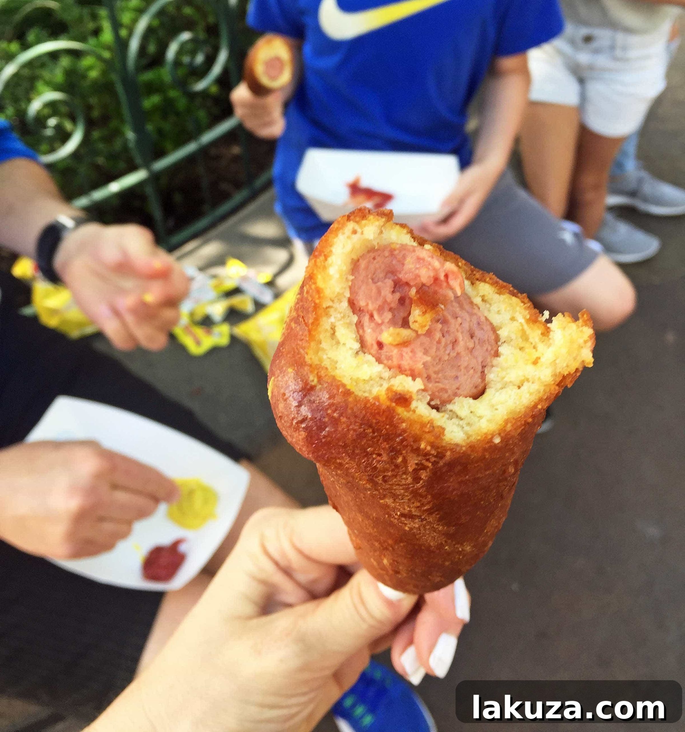 Disneyland's Gastronomic Gold: Essential Eats & Sweet Treats 5 Disneyland's famous hand-dipped corn dog from the Little Red Wagon. A truly unique and delicious crispy fried treat that stands out from typical corn dogs.