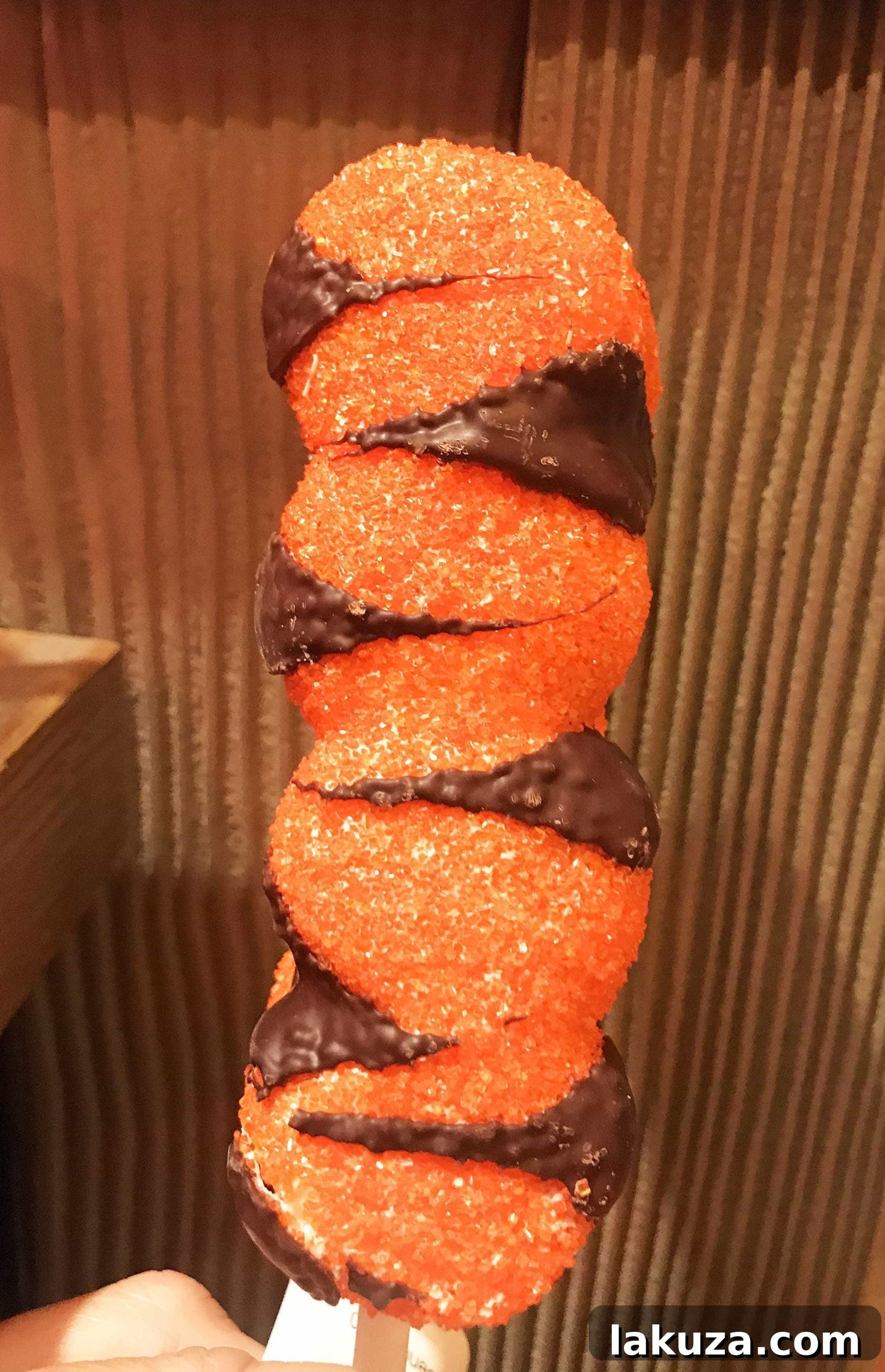 Disneyland's Gastronomic Gold: Essential Eats & Sweet Treats 11 A delightful Tigger Tail Marshmallow Wand from Pooh Corner at Disneyland, a sweet treat covered in homemade caramel and orange stripes.