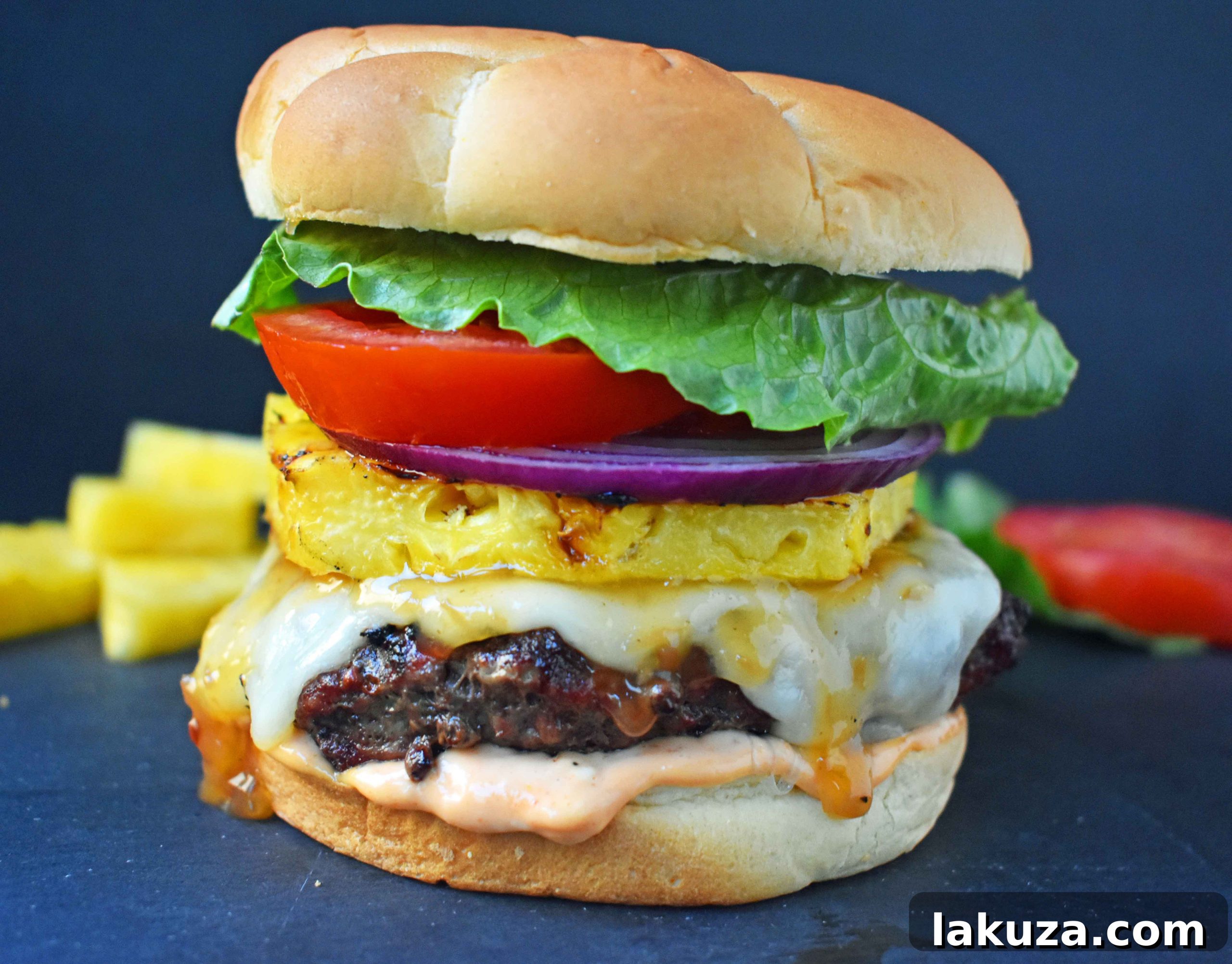 Sweet and Spicy Hawaiian Burger made with grass-fed beef, grilled to perfection, basted with a Hawaiian pineapple sauce and topped with melted Swiss Cheese. Served on a warm toasted bun with Sriracha mayonnaise, grilled pineapple, fresh lettuce, tomato, and red onion. A tropical burger that transports you straight to the beaches of Hawaii!
