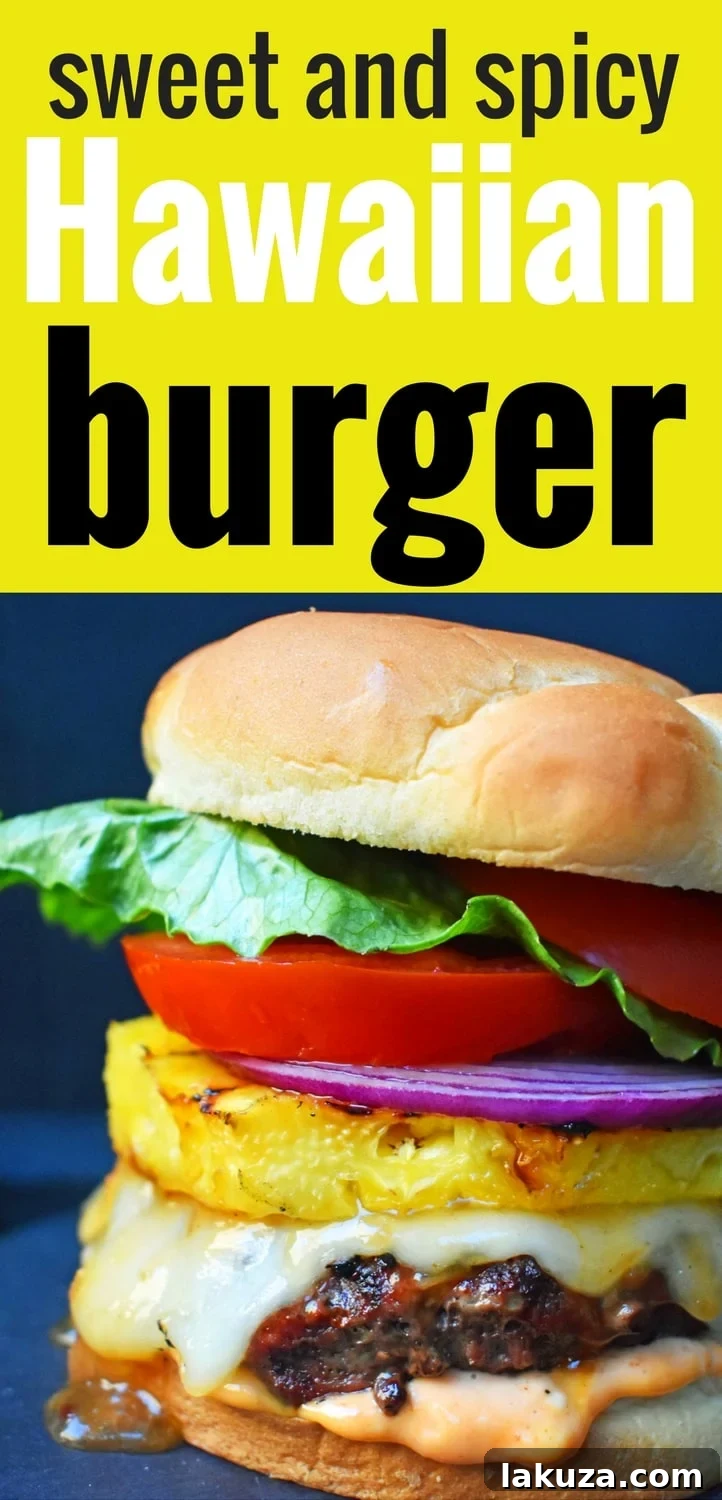 The ultimate Sweet and Spicy Hawaiian Burger, featuring a perfectly grilled grass-fed beef patty, rich Hawaiian pineapple sauce, melted Swiss, juicy grilled pineapple, creamy Sriracha mayonnaise, crisp lettuce, tomato, and red onion, all on a toasted bun. A tropical escape for your tastebuds.